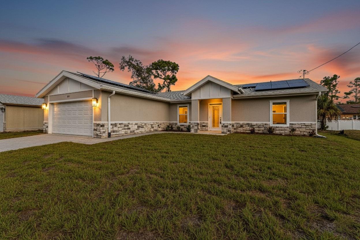 One or more photo(s) has been virtually staged. Built for Strength, Efficiency & Comfort! This brand-new 3-bedroom, 2-bath home with a den/office offers modern style and exceptional durability. Constructed with Structural Insulated Panels (SIPs) featuring an insulating foam core and cement board exterior, this high-performance system can withstand winds up to 200 mph. SIPs are fire-resistant, self-extinguishing, non-toxic, and resistant to mold, corrosion, and termites—providing long-term safety and peace of mind.
Step inside to a light and bright open split floor plan featuring luxury vinyl plank flooring, quartz countertops, and stainless steel appliances in the stylish kitchen. The den with barn doors provides the perfect flex space for an office or guest room. The primary suite offers a walk-in closet and an ensuite bathroom with dual sinks and a walk-in shower. Guest bedrooms are generously sized for comfort and versatility.
Enjoy year-round savings with energy-efficient Low-E windows. Outside, step into your large backyard—a blank slate to create your own outdoor oasis. Conveniently located close to dining, shopping, and local amenities, this NON-HOA home in an X flood zone means no flood insurance required and the freedom to live your way.
Combining cutting-edge construction with modern finishes, this North Port home sets a new standard for comfort, efficiency, and durability.