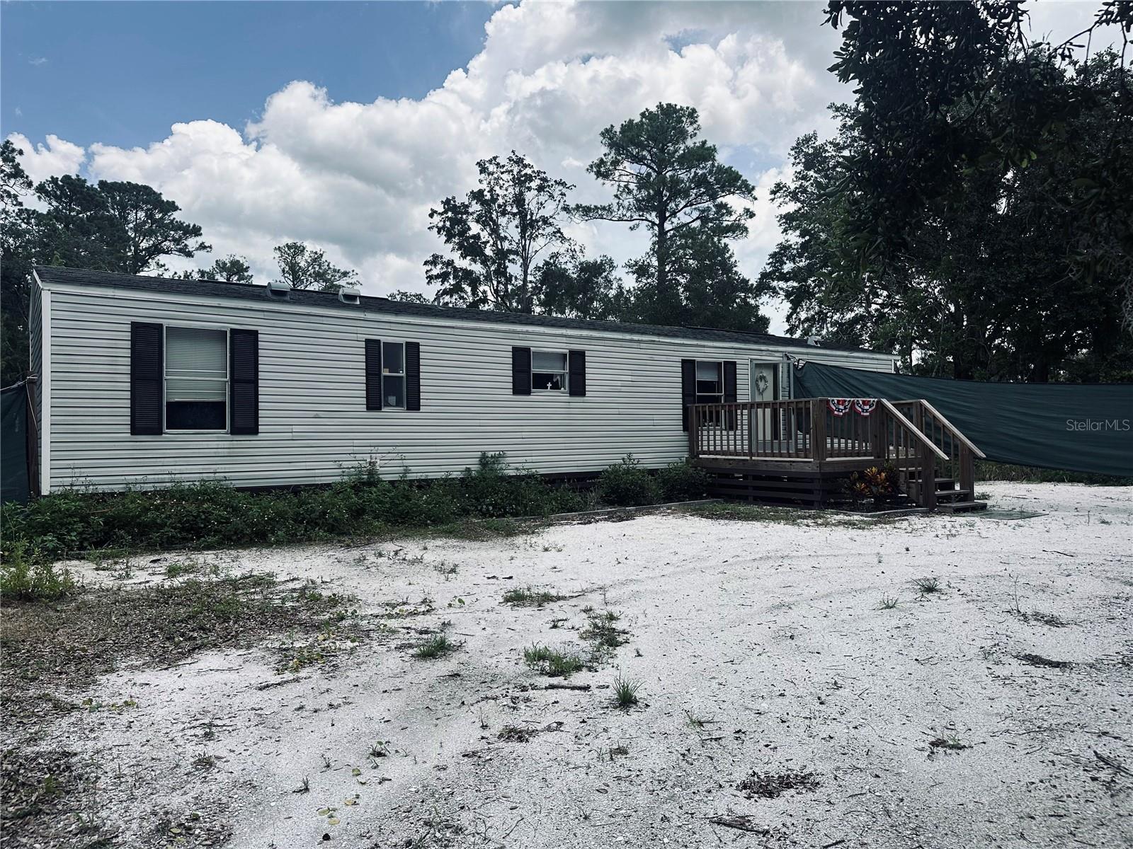Single wide mobile home on 1.25 acre of property in the quiet neighborhood of Mims, Florida.