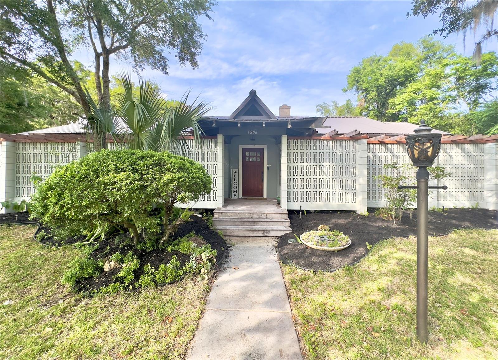Under contract-accepting backup offers. Enjoy your own hidden oasis just outside of historic downtown Leesburg with NO HOA or any extra associated fees!!! This historic home has striking Polynesian architecture blended with meticulous updates, giving you all the latest conveniences while maintaining the integrity of a historical home. Fully renovated in 2020: New metal roof, insulation, windows, electrical, water heater, AC, plumbing, painted inside/out, new kitchen, bathroom, flooring, light fixtures, ceiling fans, landscaping & more! Additional noteworthy amenities of the home are the high ceilings, crown molding, wide baseboards and an extra-large laundry room that could be used as an office. You will love the recessed lighting in every room, open floor plan and top of the line finishes throughout. Bedrooms and bonus room have original hardwood floors, while high-end laminate is in the great room and kitchen. Bathrooms and laundry room have gorgeous porcelain tile. The Gourmet kitchen with island includes custom 42" cabinets, quartz countertops, stainless steel appliances, gas stove & double convection oven. Working wood-burning fireplace provides a beautiful focal point in the living room. Bonus room which overlooks a koi pond, can be used for den, play area, office or media room. The 4th bedroom shares the master bathroom, creating a luxurious double master bedroom retreat. Master bath boasts custom tile work, quartz countertops, double vanities, large tub and separate shower. This split floorplan, has 2 additional bedrooms on the opposite side of the home which share a full bath with original storage featuring a built-in hamper. The almost 1/2-acre lot with abounding trees and vegetation includes an Orange Tree, Grapefruit Tree, and Loquat Tree. The ample room gives you an illusion that you are miles away from the city, yet you are just a few blocks to town! A very private drive at the rear of the home, takes you through luscious greenery to a circular driveway with ample parking. The Majestic oak tree and specially made bamboo fence provide privacy & a peaceful setting that is perfect spot for any bird watcher. Bring your Boat, Jet Skis, and friends to one of the many lakes that are conveniently located nearby including Lake Harris, Lake Griffin, and Lake Eustis. This unique property is truly a must see! Schedule a private showing today!