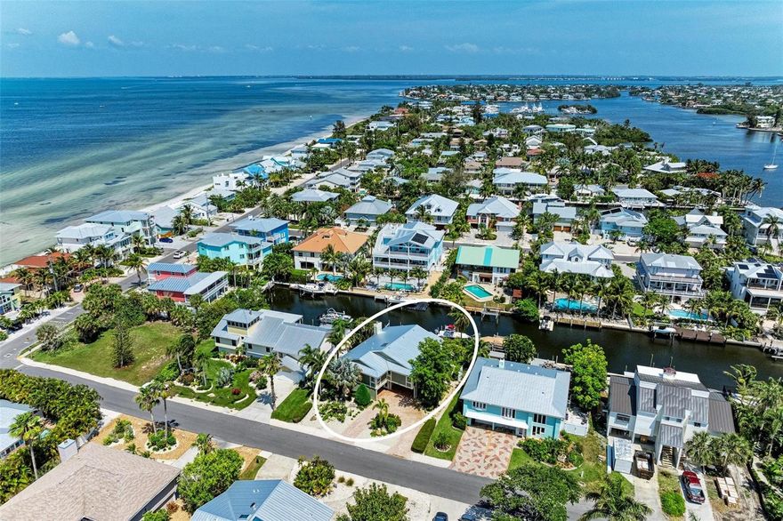 Embrace the Anna Maria Lifestyle in this Absolutely Lovely 3 bedroom/3 Bath, Canal Front North-End Home.  Outdoor Island living at its finest - deep/wide canal with no fixed bridges to the bay, charming heated, salt water pool/spa with travertine and Azek decking, welcoming seating area, and 2 boat hoists,. Just within the retractable door is an entertaining/gathering delight featuring a large bar with a built in grill and hood, refrigerator, sink, TV, travertine flooring and large seating area.  Upstairs, this gracious residence offers open living space with high ceilings, ceramic tile throughout, sliding doors to the balcony, a well appointed kitchen and bar area, decorative fireplace, and large, comfortable living area with a ceiling mounted TV projector and motorized screen.  The master suite features a large walk in closet, and bath with glass block shower, claw foot garden tub, and double sinks.  The second bedroom also has a connecting bath with two sinks and separate shower.  The roof was replaced in 2022, AC in 2019, and whole house duct replacement in 2023. The lower level has been recently renovated with Enduro Flood and a new Bathroom.  Rental history is available upon request. Meticulously maintained and ready access to Tampa Bay, Island shops and restaurants, and the Gulf of Mexico.  It just might be right time to call Anna Maria Island your new home.