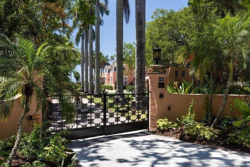 Nestled on 1.1 acres of pristine bayfront along Sarasota Bay, Etowah stands as a timeless icon of Sarasota’s rich architectural heritage, offering sweeping, wide-open bay views to the north and south, from the manicured lawn at the water’s edge all the way to the distant skyline of downtown Sarasota, with glowing sunset views that unfold nightly across the horizon. Originally built in 1925, this distinguished two-story Mediterranean Revival estate spans over 6,500 square feet and commands captivating views across the bay, all while being just 10 minutes from downtown Sarasota. Following an extensive year-long restoration, Etowah has been meticulously renewed from the inside out. Every major system of the home has been comprehensively replaced or upgraded, including all new electrical, plumbing, heating and air-conditioning systems, roofing, insulation, and drywall, ensuring modern performance while preserving historic integrity. A significant west-side addition by renowned local architect Frank Folsom Smith in 1992 introduced a gracious primary suite, a sophisticated bar area, and a grand great room—enhancements that seamlessly complement the home’s historic character. Upon entry, a vaulted ceiling sets a dramatic and welcoming tone, guiding you into the formal living room anchored by the home’s original fireplace. The adjacent dining room, surrounded by windows crafted with original glass sourced from the nearby Ringling era, creates an extraordinary setting for entertaining and comfortably accommodates gatherings of 12 or more. Designed for both elegance and performance, the chef’s kitchen is outfitted with top-of-the-line Thermador appliances, a Sub-Zero refrigerator, and every modern convenience, while the sun-filled eat-in area offers the perfect spot for morning coffee overlooking the grounds. The west wing of the home unfolds around a serene courtyard, with the great room and owner’s suite positioned on either side—creating a seamless indoor-outdoor living experience. The owner’s suite features sweeping bay views, dual walk-in closets, and a spacious spa-like bath. Upstairs, a second primary bedroom offers its own wood-burning fireplace, picturesque bay vistas, and generous closet space. 3 additional bedrooms on this level are well-proportioned and thoughtfully laid out, complemented by a sunken office or den tucked quietly at the end of the hall. The grounds are equally exceptional, highlighted by a heated, resort-style 15’ x 50’ swimming pool—perfect for both relaxation and entertaining. Completing the waterfront setting is a 4’ x 50’ dock, providing direct access to Sarasota Bay for boating, paddleboarding, and waterfront enjoyment. Completing the property is the original detached garage with an adjoining workshop, gardening space, laundry facilities, and private guest quarters—ideal for visitors or staff. A rare offering of architectural significance and modern luxury, Etowah is a one-of-a-kind estate that seamlessly bridges historic Florida elegance with contemporary living, all set against the unparalleled beauty of Sarasota Bay.