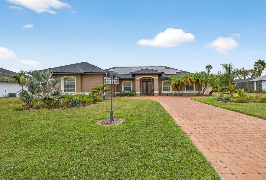 One or more photo(s) has been virtually staged. Welcome to your stunning new home, a beautifully designed three-bedroom, two-bathroom residence with a bonus room that’s florida style living with tranquil lakeside charm. As you enter, you’ll be captivated by the open-concept layout that seamlessly connects the spacious living area to the gourmet kitchen, making it ideal for entertaining and family gatherings.

The kitchen is a culinary dream, featuring granite countertops, a gorgeous marble backsplash, and wood cabinets that provide both style and functionality. The thoughtful design allows for ample storage and prep space, ensuring that cooking is a pleasure.

Retreat to the serene primary suite, which offers a private en-suite bathroom with a jacuzzi tub and a peaceful atmosphere, perfect for unwinding after a long day. Two additional bedrooms are generously sized, making them perfect for family, guests, or a home office.

Step outside to your personal paradise—an inviting private pool that overlooks a beautiful lake view. The outdoor space is perfect for summer barbecues, relaxing afternoons, or simply taking in the stunning sunsets over the water.
This home also offers a 1-year-old roof, 2-year-old HVAC and newly installed solar panels for energy efficiency.
With custom touches throughout and a location that offers both privacy and community, this home is a rare find. Don’t miss your chance to experience lakeside living at its finest!