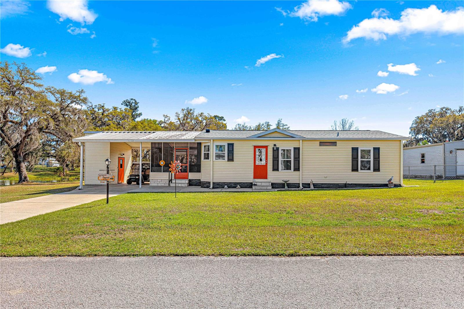 Welcome to your dream manufactured home, where value and quality meet in this carefully maintained 2-bedroom, 2-bathroom retreat, complete with land ownership! Perfect for year-round living or a winter getaway, this property has it all.
This home is has been well-maintained—it's been extensively upgraded including 10 newer windows, newer roof and newer H.V.A.C. all in 2022 ,
As you drive up, you'll be greeted by an oversized carport, leading you to a spacious screened porch with solid wood plank flooring. This airy space is ideal for curling up with a book or savoring a refreshing iced tea while enjoying the water view, there is a nice pond right next to this home where you can enjoy viewing different species of birds, see some turtles and even do a little hobby fishing. Inside, you will be greeted by the open living area, enhanced by vaulted ceilings and elegant luxury vinyl laminate flooring—no carpet here!
The dining area effortlessly connects to both the family room and modern upgraded kitchen, making it a fantastic space for entertaining family and friends. Enjoy the added convenience of a large pantry closet in the kitchen.
The primary suite, boasts an ensuite bath with a walk-in shower, providing a serene retreat. The guest bedroom has a guest bathroom right across from it. Outdoor lovers will appreciate the pond next to it. This home sits on a 1/4 acre, which enhances the backyard fenced in space, along with the extra storage offered by the backyard shed.
With a low monthly HOA that covers trash and water services, and all the amenities including a community pool this home sits on a prime location providing easy access to travel to The Villages, Ocala, major highways, and I-75. Don’t let this opportunity slip away! Schedule a showing today in person or virtually and discover all that this lovely home has to offer!