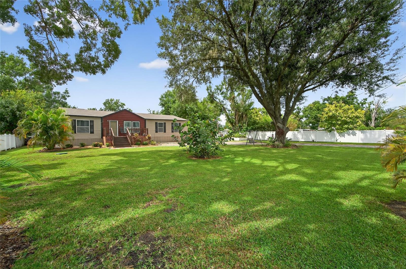 This 4 Bedroom, 2 Bathroom home, located on a private and peaceful 1-Acre (MOL) of land, is now available for viewing. The backyard offers a wonderful pond view, a storage shed, and an 'office' shed - with laminate flooring, electric and AC. You can continue to explore endless possibilities by adding a pool, garden, outdoor entertainment area or guest house. There is a second septic system located at the back of the property, great for adding an additional building. Once you step inside you will appreciate the open and airy feel of the main living space, connecting the family room, kitchen and dining area. The kitchen features a functional layout and includes a full appliance package, a breakfast bar, ample counter space and cabinet storage, and neutral finishes which create an inviting atmosphere for both everyday meals and entertaining. The split plan offers the master bedroom to the left, which incudes a full ensuite with separate soaking tub, stand alone shower and a walk in closet. The second bathroom and 3 additional bedrooms are conveniently located to the right of the home. Rounding out this wonderful property is a dedicated laundry area. Upgrades/amenities: AC 2024, new vinyl fencing on sides of the home, new vinyl flooring throughout, new light fixtures throughout.