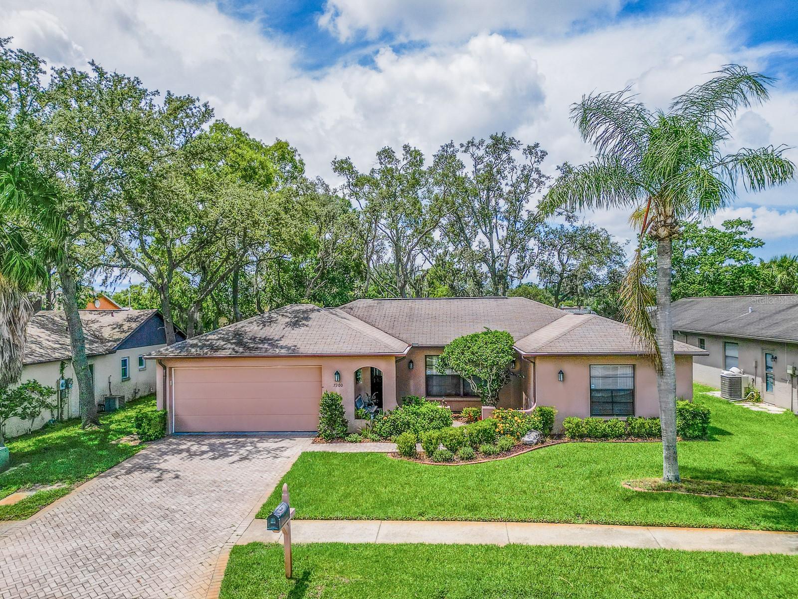 Welcome to your future oasis! This charming 2-bedroom, 2-bathroom, 2-car garage home offers the perfect blend of comfort and potential. Built in 1988 and located in a non-flood zone, this well-situated property invites you to enjoy peace and relaxation both inside and out.
From the beautifully landscaped front courtyard to the covered and screened lanai, every detail of this home exudes warmth and livability. Inside, you’ll find a spacious layout featuring a comfortable living room, a cozy family room, and a separate dining area with a convenient breakfast bar—perfect for both entertaining and everyday living.
The large primary suite is a true retreat, with private access to the pool area, ample closet space, and an expansive ensuite bathroom offering double sinks, a makeup vanity, and a tub/shower combination. The second bedroom is well-sized, and the second full bath features a smartly designed step-in shower.
Step outside to enjoy your private swimming pool in the screened lanai—ideal for relaxing or hosting guests. With just a bit of TLC, this home is ready to become your dream Florida getaway.
Centrally located, this property is just minutes from restaurants, shopping, and downtown New Port Richey. North Bay Hospital is nearby, and both Tampa International Airport and Honeymoon Island are less than a 45-minute drive away. Please note: the water softener is not currently functioning, and the washer and dryer are included as-is.
Don’t miss this opportunity to create the lifestyle you’ve been dreaming of—schedule your showing today!