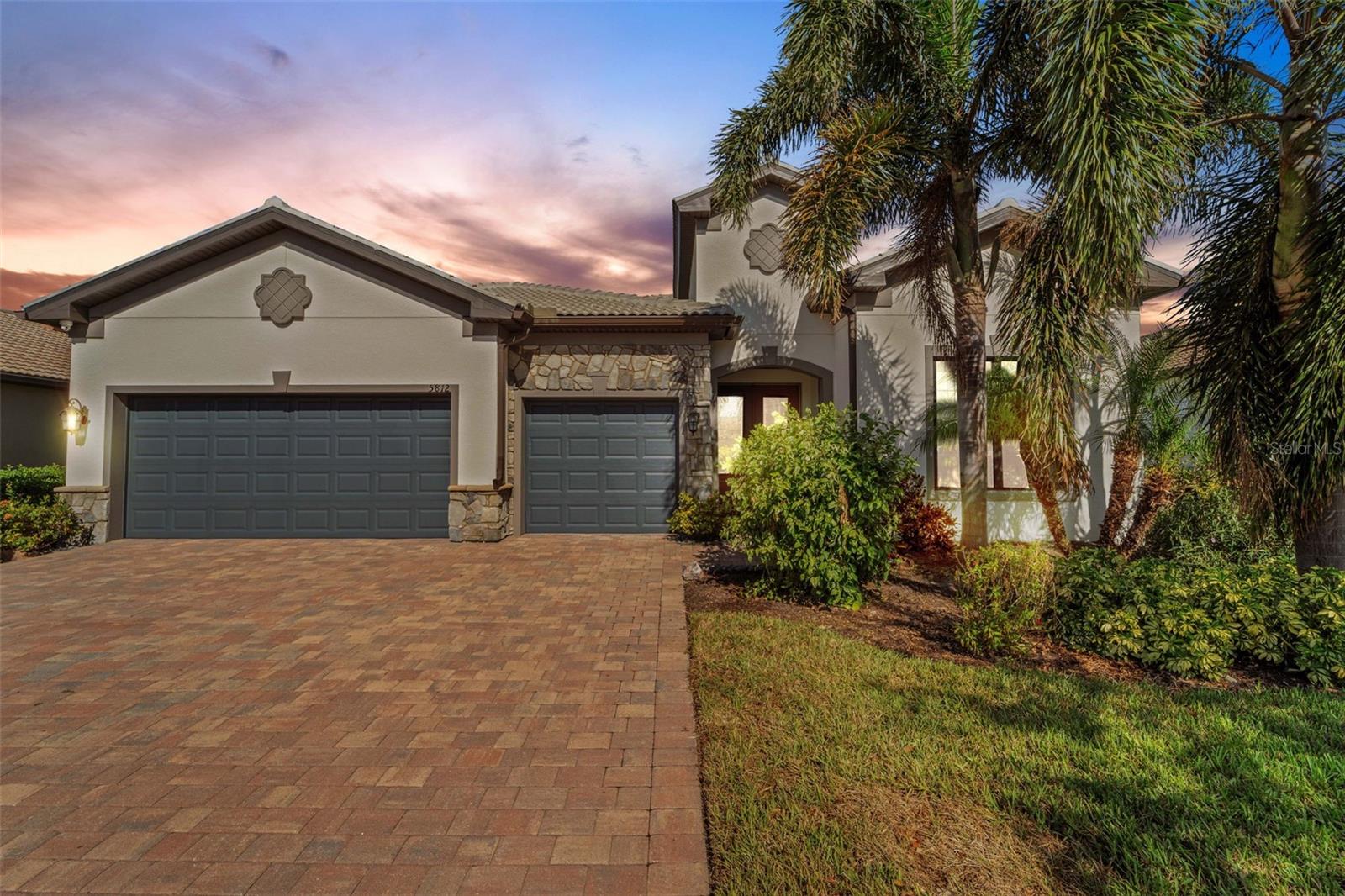 Introducing an exquisite luxury home in the highly coveted Hammock Preserve, an amenity-rich, gated community in the heart of central Sarasota. This stunning residence offers both convenience and leisure, situated just moments from downtown Sarasota and the world-famous Siesta Key Beach. As you approach the home, you’ll be captivated by the elegant stone façade, beautifully landscaped entryway, and grand double-door entrance, setting the tone for the refined elegance inside. Step through the 8-foot interior doors into a bright, inviting space. The chef's kitchen features 42" cabinets, pull-out drawers, a natural gas cooktop with vented exhaust, and upgraded stainless steel appliances, including a French door refrigerator and a double oven with convection cooking. The large quartz island with a deep single sink is perfect for both meal prep and casual dining. Additional highlights include a reverse osmosis system for the sink and refrigerator, as well as a whole-house water softener. The home is designed with a clean, neutral palette, complemented by designer lighting and fans, adding sophistication throughout. A dedicated study with glass French doors provides a quiet space for work or relaxation. The living room exudes character with a coffered ceiling and a freestanding electric fireplace w/marble accent. The spacious owner’s suite is a true retreat, offering walk-in closets with custom built-ins and a luxurious bathroom featuring an oversized walk-in Roman shower, dual-sink vanity with quartz counters, and a private water closet. Both guest bedrooms are designed as private suites, separated by a pocket door and a full bath—perfect for hosting family and friends. The Full 3-car garage offers ample space for vehicles and storage, complete with a separate air conditioning unit. Situated on a beautiful pond, the expansive lanai, shaded all day due to its north-facing position, is ideal for year-round enjoyment, while an extended pavered outdoor space provides additional room for sunbathing and admiring the picturesque water view. For added convenience, the front window is high-impact, and all other windows feature accordion shutters, making it easy to secure the home in minutes. The property also includes a whole-house Generac generator installed in 2024 with a 10yr Warranty, in-wall pest control, and a security system with cameras inside and out for peace of mind. Plus, with NO CDD fees, this home is as practical as it is beautiful. Hammock Preserve offers resort-style living with amenities such as tennis, pickleball, a community pool, fitness center, and Tiki bar. Don’t miss the chance to own this exceptional home in an incredible location!