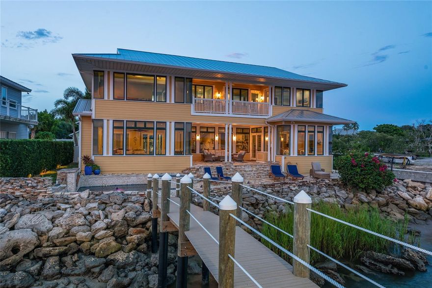 Wide Intracoastal Views and Understated, Refined Coastal Living Await You. Truly TURN KEY! Come See this Direct Intracoastal Front Home on New Smyrna Beach’s coveted SpyGlass Lane. Perfectly situated on a private cul-de-sac and deep, wide water. Spectacular views from all the main living spaces. Minutes to the Inlet and a short walk to the beach, you can’t get a better location than this! The address may be SpyGlass Lane but no telescope is required to enjoy the dolphin show and constant boat parade from the comfort of this stunning custom home. From the moment you enter, your eyes are drawn to the incredible water views and open spaces. From the gracious entry area you immediately notice the high level of custom details distinguishing this home. The large living room features a natural gas fireplace and custom built-in cabinetry. From the living room you have immediate access to the spacious covered porch and to the adjacent dining area doubling as a billiard room through the magic of a custom pool/dining table. Flowing from the dining area you are invited into the large "Chef's" kitchen and family room spaces. The kitchen features a walk-in pantry and high end stainless appliances including: french door refrigerator with "flex" drawers for either freezer or additional refrigerator space, natural gas six burner range plus griddle and two ovens, range hood, dishwasher, microwave, warming drawer and beverage refrigerator. The center piece of the kitchen is a 6' x 9' island with gorgeous stone counter top and integrated counter height seating. Adjacent to the kitchen is a large family room with an additional natural gas fireplace, walls of windows and french doors opening to the river front porch. The elevated porch allows for views to the pool and spa, flagstone patio and the brand new (2025 built) dock with covered boat lift. A full bathroom on the main level allows for quick access to the pool area and for rinsing off after fishing or a morning in the surf. Store the golf cart, scooters, fishing equipment and surfboards in the over-sized two bay garage with custom epoxy floor covering and built-in storage system. Upstairs you find five bedrooms and four more full bathrooms. Also upstairs is a large media/bonus room with sink, refrigerator, cinema seating and built-in cabinetry. The Primary Suite offers spectacular river views and an elegant primary bath with garden tub, separate shower, double sinks, marble counter tops and a private water closet. This jewel on the river was beautifully renovated in 2018. Metal Roof new in 2022. Three Separate A/C units all new in 2018. Brand new elevated Dock with covered 12,000 lb lift completed in August 2025. The new dock includes a 4 Pole Setup to accommodate additional, large boat. Be sure to check out the photos and Virtual Tour / Video to fully appreciate this special home and spectacular location. Measurements are approximate and Buyer responsible to verify all dimensions.