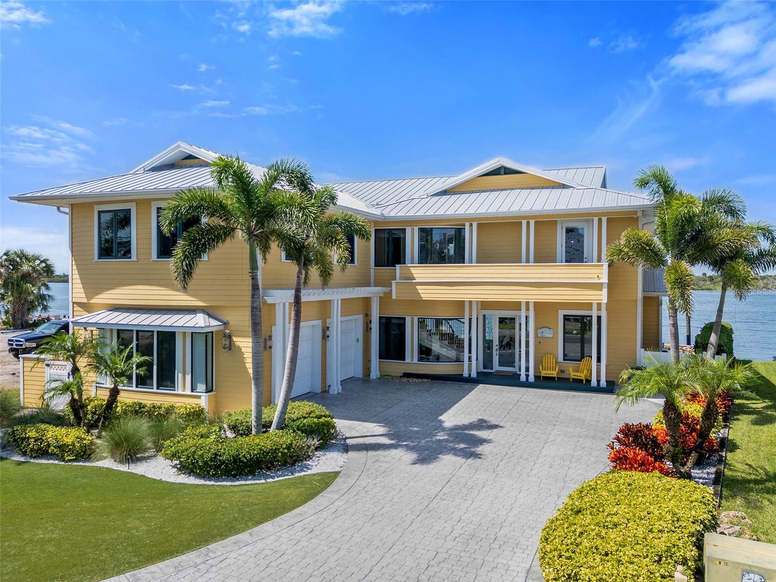 Understated Elegance and Refined Coastal Living Awaits You. Direct Intracoastal Front Home on New Smyrna Beach’s coveted SpyGlass Lane. Perfectly situated on a private cul-de-sac and deep, wide water. Spectacular views from all the main living spaces. Minutes to the Inlet and a short walk to the beach, you can’t get a better location than this! The address may be SpyGlass Lane but no telescope is required to enjoy the dolphin show and constant boat parade from the comfort of this stunning custom home. From the moment you enter, your eyes are drawn to the incredible water views and open spaces. From the gracious entry area you immediately notice the high level of custom details distinguishing this home. The large living room features a natural gas fireplace and custom built-in cabinetry. From the living room you have immediate access to the spacious covered porch and to the adjacent dining area doubling as a billiard room through the magic of a custom pool/dining table. Flowing from the dining area you are invited into the large "Chef's" kitchen and family room spaces. The kitchen features a walk-in pantry and high end stainless appliances including: french door refrigerator with "flex" drawers for either freezer or additional refrigerator space, natural gas six burner range plus griddle and two ovens, range hood, dishwasher, microwave, warming drawer and beverage refrigerator. The center piece of the kitchen is a 6' x 9' island with gorgeous stone counter top and integrated counter height seating. Adjacent to the kitchen is a large family room with an additional natural gas fireplace, walls of windows and french doors opening to the river front porch. The elevated porch allows for views to the pool and spa, flagstone patio and the brand new (2025 built) dock with covered boat lift. A full bathroom on the main level allows for quick access to the pool area and for rinsing off after fishing or a morning in the surf. Store the golf cart, scooters, fishing equipment and surfboards in the over-sized two bay garage with custom epoxy floor covering and built-in storage system. Upstairs you find five bedrooms and four more full bathrooms. Also upstairs is a large media/bonus room with sink, refrigerator, cinema seating and built-in cabinetry. The Primary Suite offers spectacular river views and an elegant primary bath with garden tub, separate shower, double sinks, marble counter tops and a private water closet. This jewel on the river was beautifully renovated in 2018. Metal Roof new in 2022. Three Separate A/C units all new in 2018. Brand new elevated Dock with covered 12,000 lb lift completed in August 2025. The new dock includes a 4 Pole Setup to accommodate additional, large boat. Be sure to check out the photos and Virtual Tour / Video to fully appreciate this special home and spectacular location. Measurements are approximate and Buyer responsible to verify all dimensions.