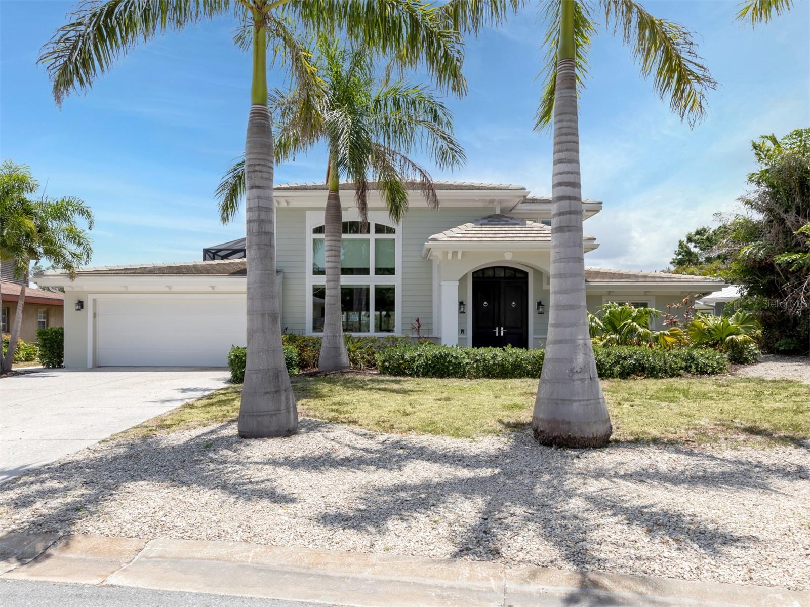 Stunning Sarasota waterfront home leading to Intercoastal Waterway! Current owner purchased home in 2016 and completed a ground up renovation to current hurricane code that concluded in 2018. This home was a labor of love with absolutely NO upgrades or details spared. This home features 4 bedrooms, 3.5 baths with beautiful travertine flooring on lanai and downstairs bathrooms, striking tile and engineered hardwood on interior flooring, an expansive outdoor entertaining area with outdoor shower and gorgeous salt-water pool with fountains enclosed in a Cat 3 rated Clearview cage overlooking Phillippi Creek. Attention boaters, this home comes with a 10,000 lb. aluminum boat lift with electric and water on private dock – you can jump on your boat and be in the intercoastal waterway on your way to the Gulf of Mexico in 5 minutes. New in 2018 include tile roof, hurricane windows and doors throughout, electronic hurricane shutters that cover the 1st and 2nd floor impact sliders, a full house natural gas Generac generator, 2 AC units, custom kitchen with solid maple cabinets, Wolf range, Wolf microwave, Miele dishwasher, two tankless natural gas water heaters, a two-car garage with metal storage cabinets (great for the Florida weather) and a newly installed garage AC/heat unit. The stunning bar area across from the kitchen includes Sub Zero appliances: two refrigerator drawers, ice maker and wine refrigerator. On the first floor you will find a large master with beautiful en suite bathroom. The master en suite bathroom contains a modern soaking tub and walk in shower. A main floor half bathroom is off the pool and kitchen/family room. Upstairs you will find three spacious bedrooms, one with an en suite bathroom and the additional two bedrooms have access to a modern hall bathroom. Two of the three upstairs bedrooms open to beautiful second floor balcony featuring natural cypress ceilings. The coffered high ceilings in the family room make this a truly inviting, spacious home for everyday living or entertaining. This home features a full home security system and well for the sprinkler system. If this is not enough, the owner installed a crushed concrete gravel driveway for an RV or camper which includes a hook up for water and electric. No deed restrictions or HOA fees! Do not miss this one-of-a-kind home that is close to Siesta Key Beach, Tamiami Trail, downtown Sarasota and all the shopping, restaurants, and entertainment that Sarasota has to offer!