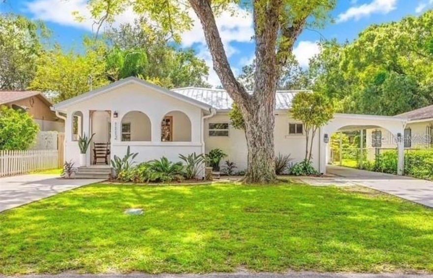 Beautifully updated Spanish-inspired bungalow nestled in Tampa’s sought-after Lowry Park neighborhood. Originally built with character and charm, this stunning home was thoughtfully renovated in 2021, blending timeless appeal with modern updates. Featuring a durable and stylish metal roof, this home offers both peace of mind and lasting curb appeal. Inside, you'll find a spacious open-concept layout that includes two bedrooms and two full bathrooms across approximately 1,600 square feet of thoughtfully designed living space. Vaulted ceilings and large windows flood the interior with natural light, while luxury vinyl and tile flooring create a sleek, cohesive look throughout. The living and dining areas flow effortlessly into the modern kitchen, which boasts stone countertops, updated appliances, and a comfortable space perfect for cooking and entertaining. A split-bedroom floor plan offers privacy with the primary suite equipped with a walk-in closet. Additional features include ceiling fans, custom window treatments, and a full laundry area with washer and dryer included. The exterior of the home is just as impressive with a driveway and a two-car carport providing plenty of parking. The generous 6,600-square-foot lot offers ample outdoor space to garden, entertain, or simply relax. Ideally situated just minutes from Zoo Tampa, Seminole Heights, and less than five miles from downtown, this home provides the perfect mix of suburban comfort and urban convenience. Whether you're heading to the city or the beach—just under an hour away—you'll enjoy easy access to the best of the Tampa Bay lifestyle. Stylish, solid, and move-in ready, this home is a rare find in one of Tampa’s most vibrant and established neighborhoods.