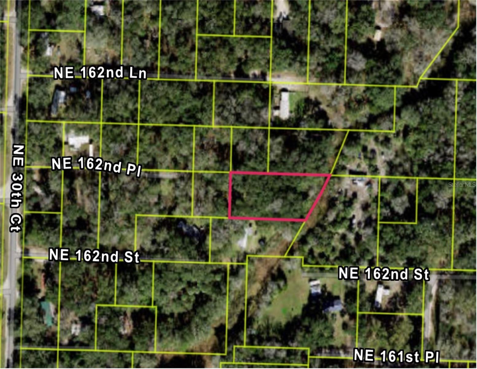 Peaceful Half-Acre Retreat – Close to Gainesville & Ocala! Discover a hidden gem just over half an acre, tucked away from the hustle and bustle of the city yet conveniently located near Gainesville and Ocala. Whether you're looking to build a weekend getaway or create your own country escape, this versatile lot offers the freedom to make it truly your own. With no HOA, you'll enjoy the flexibility to bring your vision to life. The property is bordered by a canal on one side, adding a touch of natural charm and potential for serene views. Nearby lots are already equipped with septic and well, making utilities more accessible. Embrace the beauty and simplicity of Florida country living—spacious, peaceful, and full of potential! INFORMATION IS DEEMED RELIABLE BUT NOT GUARANTEED…TO BE VERIFIED BY THE BUYER AND/OR BUYER'S AGENT INCLUDING UTILITIES.
