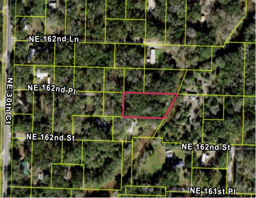 Peaceful Half-Acre Retreat – Close to Gainesville & Ocala!  Discover a hidden gem just over half an acre, tucked away from the hustle and bustle of the city yet conveniently located near Gainesville and Ocala. Whether you're looking to build a weekend getaway or create your own country escape, this versatile lot offers the freedom to make it truly your own.  With no HOA, you'll enjoy the flexibility to bring your vision to life. The property is bordered by a canal on one side, adding a touch of natural charm and potential for serene views. Nearby lots are already equipped with septic and well, making utilities more accessible. Embrace the beauty and simplicity of Florida country living—spacious, peaceful, and full of potential! INFORMATION IS DEEMED RELIABLE BUT NOT GUARANTEED…TO BE VERIFIED BY THE BUYER AND/OR BUYER'S AGENT INCLUDING UTILITIES.