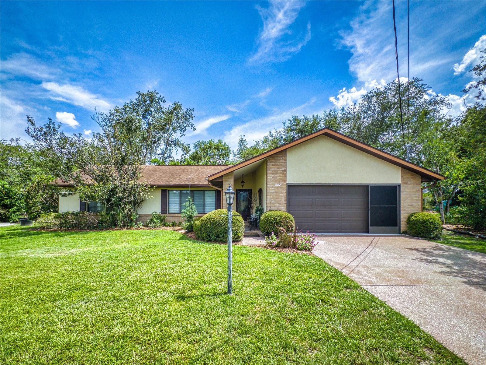 A Rare Opportunity — Spacious Home on a Double Lot with Serene Surroundings
This exceptional 3-bedroom, 2-bathroom home offers the perfect blend of privacy, space,
and convenience. Situated on a rare double lot, the property provides a peaceful, rural
atmosphere while remaining just minutes from shopping, dining, and everyday amenities.
Boasting approximately 1,698 square feet of thoughtfully designed living space—it is larger
than the 1,405 sq ft recorded in public records—this well-maintained residence has been
lovingly cared for. The open-concept kitchen (with NEW refrigerator) seamlessly connects to the living and dining
areas, ideal for both everyday living and entertaining. Energy-efficient double-pane
windows throughout the home enhance comfort and natural light, while a brand-new A/C
system, installed in 2024, ensures year-round climate control. Additional living space
added includes an 80 sq ft indoor laundry room with abundant cabinet storage, reclaimed
from the oversized garage, and a 213 sq ft family room, originally a trussed screen porch,
this inviting space features expansive double-pane windows offering panoramic views of
the beautifully landscaped and secluded backyard. Step outside and immerse yourself in a
tranquil, natural park-like setting. Winding walking paths have been thoughtfully carved
into the natural hillside, creating a Zen-inspired retreat perfect for peaceful reflection or a
quiet morning stroll among nature.
Homes with this unique combination of space, location, and serenity are truly hard to
find—don’t miss your chance to make this one your own.