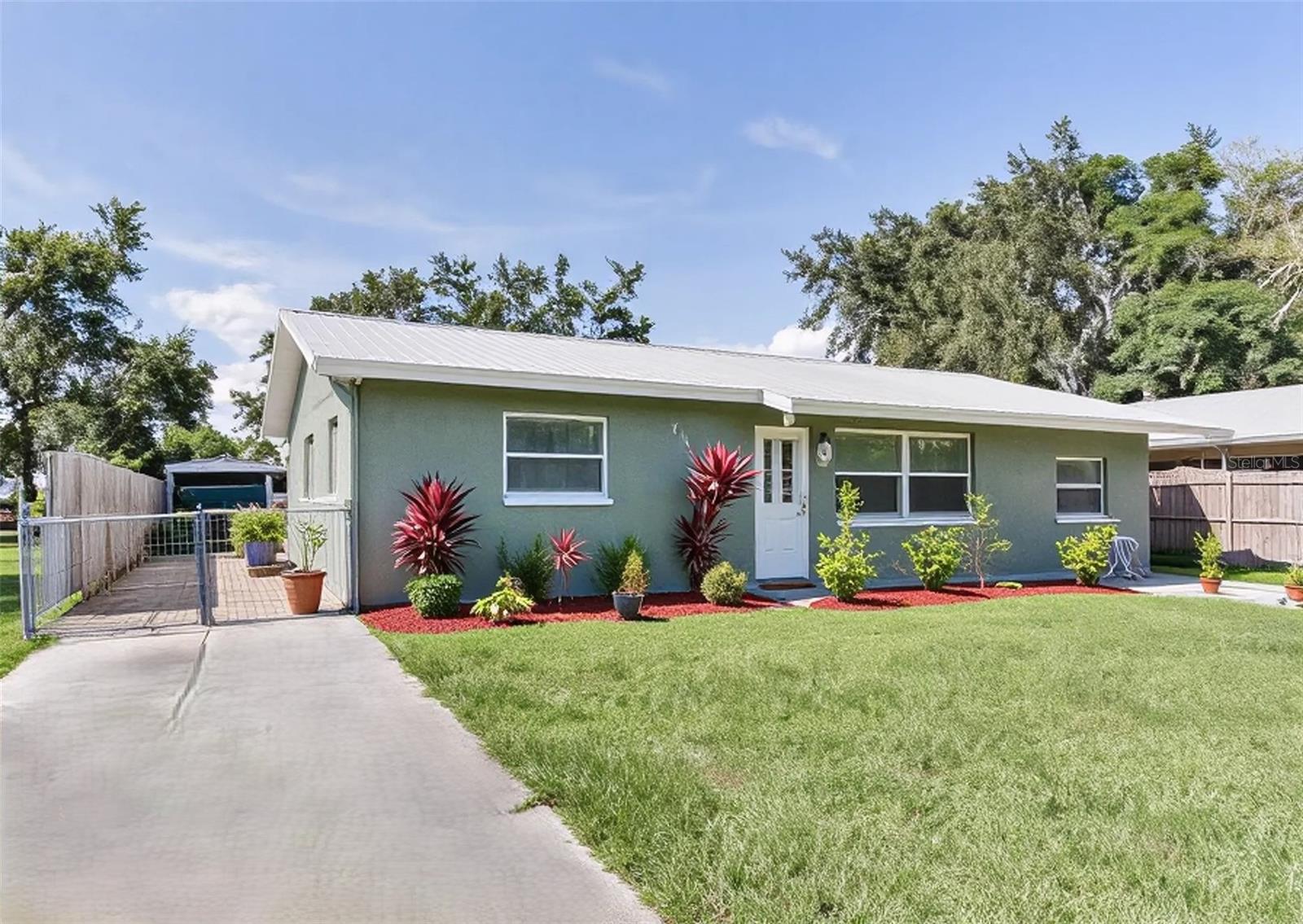 Available now for annual lease. This gorgeous sprawling one story ranch style house has 1608 Sq Ft under roof including a covered screened lanai for outdoor enjoyment, in addition to a 624 SqFt Oversized 2 car garage plus a 3 bay Carport 21x29 for an additional 609 SqFt and a storage shed that is 10 x14. Plenty of room for storage, boat, rv, or car enthusiast and more. No HOA restrictions.
The home has 2 spacious bedrooms and a third flex room for 3rd bedroom or office and 2 bathrooms. As you walk in you are greeted by open floor plan featuring a decorative wall with abstract wood molding, luxury vinyl wood plank flooring throughout, updated fixtures and custom lighting throughout. This home has a dream kitchen with top of the line Stainless Steel Appliances, built in oven and microwave, glass cook top and range hood, dishwasher, LG Refrigerator, encased in shaker style cabinetry with 42” uppers, decorative subway tile backsplash, and stone countertops. The bedrooms are tastefully finished with raised paneled doors, ample closet space, can lights and remote control ceiling fans. The bathrooms are impressive with Rain Shower, new fixtures, and large porcelain tile matching shower, bath, and flooring, undermount sinks and stone countertops and newer high flush commodes. This home is all concrete block with a farmhouse style metal roof adding energy efficiency. Convenient location is just 8 minutes to I-75, 16 minutes to Sarasota Airport and 28 Minutes to either At Armands Circle or Bradenton Beach.