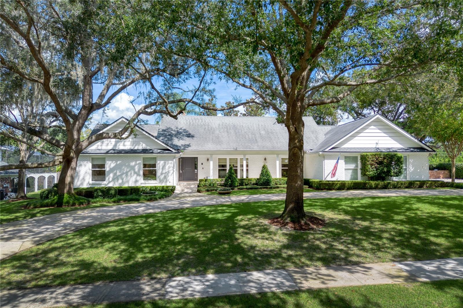 Nestled in coveted Winter Park’s Sevilla neighborhood, this 4-bed, 4.5-bath pool home delivers 3,500+ SF of refined living including 500 SF upstairs flex suite with its own full bath. A traditional foyer introduces formal living and dining rooms before the home unfolds into a spectacular 2022-renovated chef’s kitchen—an airy showpiece anchored by a 10-ft quartz island with bar seating, custom cabinetry, designer appliances, including a Thermidor side-by-side paneled refrigerator, Thermidor gas range & hood, and a Scotsman ice maker. The main hallway leads to the re-imagined primary retreat: spa-inspired bath with double vanities, oversized walk-in shower, soaking tub, dressing table, and custom closet. Two additional guest bedrooms share a refreshed full shower bath, while a separate en-suite—ideal for in-laws or overnight guests—enjoys direct access to the pool off the kitchen hall. Upstairs, a large bonus room with full bath adapts effortlessly to a 5th bedroom, media space, or private office. A utility-minded laundry/mud room links the interior to an oversized side-entry garage. Out back, entertain year-round beneath a covered lanai overlooking the expansive pool and sun deck. Mature oak canopy, manicured shrubs, and full privacy fencing create a park-like sanctuary just blocks from Park Avenue dining and the back gate to Mead Botanical Garden. Audubon K-8 and Winter Park High School District.