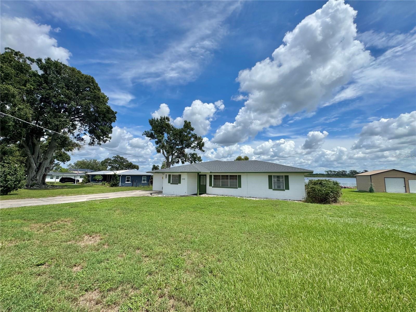 Start your mornings with breathtaking sunrises and front-row seats to seaplanes gracefully taking off and landing on the calm, scenic waters of Lake Jessie—one of the most vibrant stops on the Chain of Lakes! This charming lakefront home embodies the essence of relaxed Florida living, offering panoramic lake views and seamless indoor-outdoor spaces perfect for entertaining or simply enjoying the scenery. Step inside to an open formal living room that flows into the dining area, complete with extra storage shelves behind a mirrored wall. Large kitchen boasting ample cabinets and counter space for all your culinary needs. The heart of this home is the 17x30 great room, featuring wood beams and stunning lake views, creating a bright and inviting gathering space that seamlessly opens to an expansive 18x30 screened lanai—perfect for morning coffee or evening sunsets. With a split bedroom plan, this home offers 3 spacious bedrooms and 2 full bathrooms, all on easy-to-maintain ceramic tile floors—no carpet! Additional storage is plentiful, including closets throughout the home and a 12x18 storage shed off the inside utility room. Enjoy your private dock on this 0.61 lakefront lot, or take advantage of the public boat ramp just down the road. Centrally located between Winter Haven and Auburndale, this home offers both convenience and tranquility.