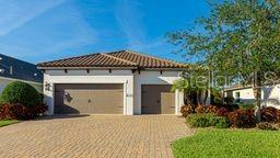 Enjoy incredible Double Lake Views, with Sunsets. If you like Peace and Quiet, plus the securty of a gated community with only 50 homes on 53 acres, and only minutes drive to the Anna Maria Island Beaches this home is for you. The Estuary Community was built by Neal Homes in 2018/2020 within Robinson Preserve where there are walking, running, biking trails, and kayak launch with trails so you can enjoy the water and nature. This home has it all a custom built heated saltwater pool with spa, comfy pool loungers. View the lake through the upgraded 45' clear screen, that includes automatic bug spraying system, or get out of the sun into the 28'x13' lanai equipped with custom powered remote control Kevlar viewing Hurricane Screens, a nice gas grill hooked to natural gas for all your cookouts. Inside you will find a very open floor plan with 18x18 tile. The gourmet kitchen has 42" Tall cabinets expresso all wood cabinets, stainless appliances, a oversized island with quarts counters, GE monogram range hood, gas cook top, Home is sold turnkey furnished with many pieces and lights from Restoration Hardware. If you need an office or extra space there is a bonus room off the living room. Coffered ceiling, double walk-in closets, and a large ensuite. Call to book appt today.