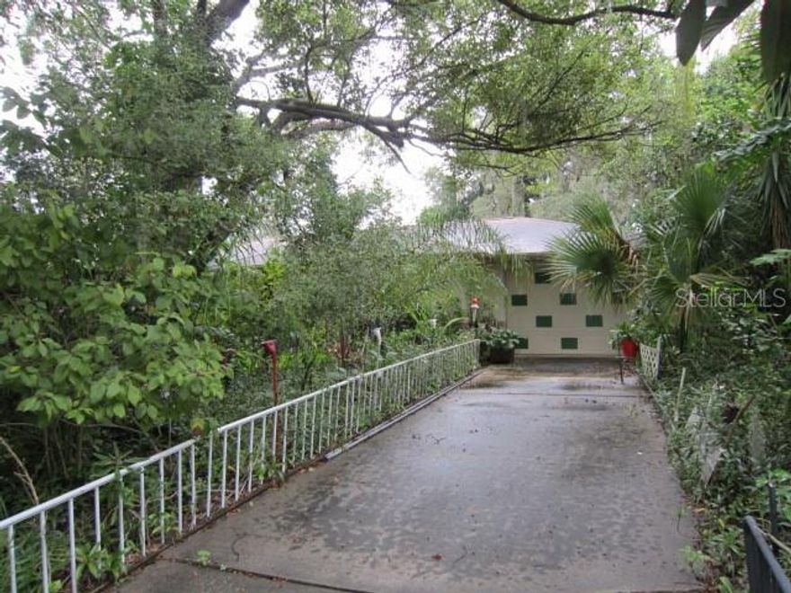 2 Bedroom 2 bath "Money Maker" plants lovers paradise, Organic garden with several types of fruit trees. Mangoes, starfruit, loquats, avocados, citrus and pineapples.  All sorts of exotic plants too.. Bromelias, Filadendros queens palms all around the property for protection from storms..  Open floor plan with huge kitchen and plenty of cabinets for storage. Wood burning stove, Florida room, eat in kitchen with bay window.   Close to shopping and I-4 30 minutes to Orlando and 25 minutes to Daytona.Call for your private showing..  This property is definitely one of a kind.  Seller will help buyer with knowledge of plants and understand how she makes money with them.