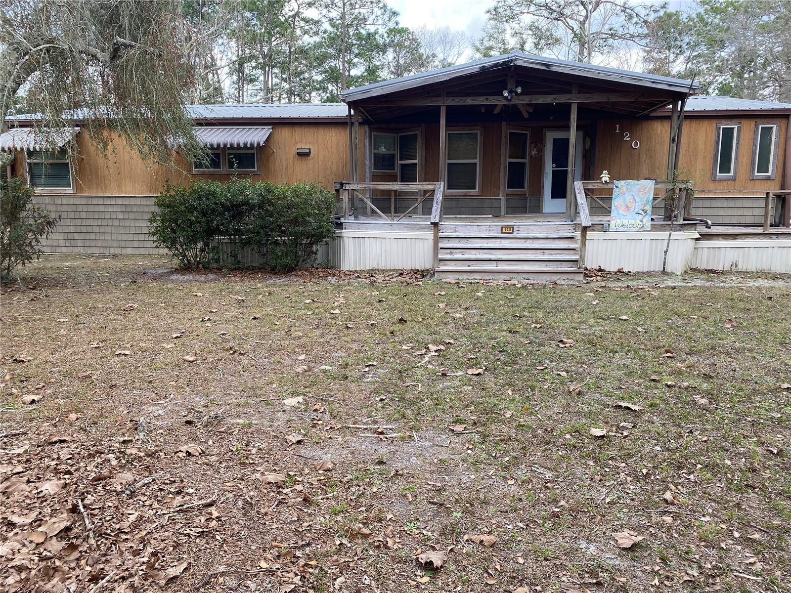 Back on the Market! This one owner and well maintained doublewide mobile home is move in ready. Inside, the spacious floor plan includes 3 bedrooms and 2 full bathrooms. The home sits on just over 2 acres and is located near the lovely town of Melrose in Ashley Lake Plantation. Rural southern lifestyle with plenty of space for your vehicles and equipment. Located on a county-maintained road with easy access to all the local activities and a short commute to Gainesville. The metal roof and the AC are just 12 years old. The windows were replaced in 2014. There are 2 sheds with electricity on the property along with a covered carport. This home has a large front porch with a wooden deck, a screened in porch in the back and includes a third backdoor entrance, and it has a wood burning fireplace. Seller is also including numerous furniture items with the home.
