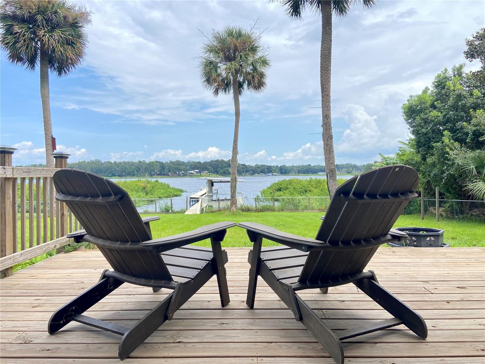 Living on Lake Time!
This beautifully remodeled 3 bedroom, 2 bath, 2 story lake home sits on a full acre, offering panoramic views of Little Orange Lake. The primary bedroom and bath are conveniently located on the main floor, while the second-story screened lanai spanning 416 sq. ft. provides breathtaking lake views. Imagine relaxing on the oversized swing, taking in the lake breeze from your perch above. Completely updated in 2023, this home features a new roof, windows, sliders, custom blinds, and fresh interior/exterior paint including refinished kitchen cabinets and new countertops. Both bathrooms have been fully renovated, and the 2nd-floor laundry comes equipped with new cabinets. Additional highlights include updated light fixtures, hardware, and restored cedar siding complemented by Hardie board plank. The reinforced dock and fully functional boat lift make lake access easy, while the party lights set the mood for evening gatherings.
The backyard boasts a 30-foot wide wood deck, new fans, lush landscaping with fruit-bearing trees, and a fenced yard. Two powered sheds offer plenty of workspace and storage. Enjoy excellent fishing, kayaking, and unforgettable sunrises from your lakefront oasis. A truly serene retreat. Excellent investment opportunity for Lakefront vacations with Airbnb. This property stays active with great reviews with airbnb! Make this your next get away!!!