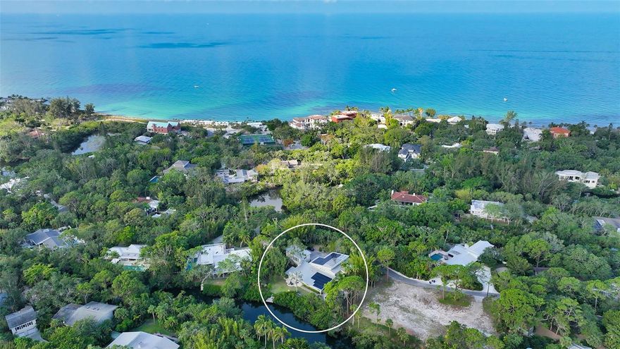 This cherished family home has been well-adored for the past two decades, and now presents a golden opportunity rarely available in the prestigious Sanderling Club, the only guard-gated neighborhood community located on the famous island of Siesta Key.  This remarkable gulf-front community is unparalleled, boasting a harmonious blend of unique architecture, meandering roads, and an idyllic Old Florida ambiance. Residents have the privilege of deeded gulf access and usage of the community’s waterfront patio and grilling area, tennis, pickleball, and volleyball courts, as well as their own exclusive beach clubhouse, masterfully crafted by the renowned architect, Paul Rudolph. Members of the Sanderling Club also have the opportunity to rent one of the historic beach cabanas or a slip for their boat, at the private bayfront marina granting access to Sarasota Bay, the Intracoastal Waterway, and the Gulf of Mexico. Step into your own personal getaway in this 5-bedroom, 5-and-a-half-bathroom, 5-car garage, 5,600 sqft residence offering ample space for your family and friends. Accommodate guests comfortably in the separate 1-bedroom, 1-bathroom, 875 sqft guest house located above the 3-car garage. Solar panels hidden on the rear portion of the metal roof power both the electricity and water heaters in both homes. Inside the main house, discover a spacious primary suite on the upper level, complete with a private balcony, large walk-in closet, and luxurious primary bathroom. Additionally offered are three guest bedrooms, and a secluded mother-in-law suite tucked away in its own private wing of the house all on the first floor. The expansive chef’s kitchen is a culinary dream, equipped with a full-size Subzero industrial fridge and freezer, Subzero beverage cooler drawers and beverage fridge, Wolf 6-burner range and double oven, two dishwashers, and a walk-in pantry. Natural light gracefully fills the home, shining in through the tall vertical windows that extend to the soaring angled ceilings. Open the high-impact German accordion doors in the sunroom and revel in the glorious indoor-outdoor experience that Florida living is all about. Create lasting family memories, whether it’s teaching the kids to cast a fishing line or launching a kayak off the backyard dock into the blue Heron Lagoon, playing fetch with the dog in the fenced in backyard, or simply unwinding with loved ones in the heated saltwater pool and spa. The opportunities are endless, and the enjoyment is eternal. The home being sold “As-Is”, offering a wonderful opportunity to make it your own and embrace the lifestyle you’ve always dreamed of.