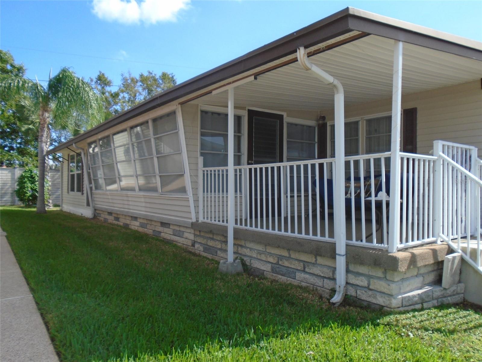 COMFORTABLE * AFFORDABLE * CONVENIENT...Sunset Palms! Lowest Price Two Bedroom in Sunset Palms * From the Welcoming Covered Front Sitting Porch to the Back Patio (with No Rear Neighbors!), this Home is Set Up to Enjoy the Florida Lifestyle. The Light Filled Living Room Hubs Off to the Right to a Second Front Living / Dining Area, or Straight Ahead to the Spacious Kitchen with Side by Side Fridge, Custom Coffee Bar Cabinet and Nearly New Stone Look Linoleum * From the Kitchen, Step Down to the Spacious Bonus Room (Heat & Air Here Too!). The Bonus Room has Sliders that Open to the Front Covered Carport. In the Back is a Separate Utility / Laundry Area that has a Door to the Back Patio. The Washer & Dryer are Nearly New...Lots of Bonus Storage Here. The Hall Bath has a Tub / Shower Combination and Two Storage Closets. The Main Bedroom Features a Half Bath. In the Second Bedroom is a Seven Foot Double Wall of Closets. Heat and Air was New in 2022. There is a Back Exit / Entrance Gate Accessible Only to Residents by Key Fob. This Way Out provides Easy Access to the Nearby Walmart with a Golf Cart Path from the Park to the Store. Sunset Palms is Over 55, No Pet Park * Seasonal Rental Are Allowed / No Annual Rentals * Share Valued at $55,000 is included in the Purchase Price.