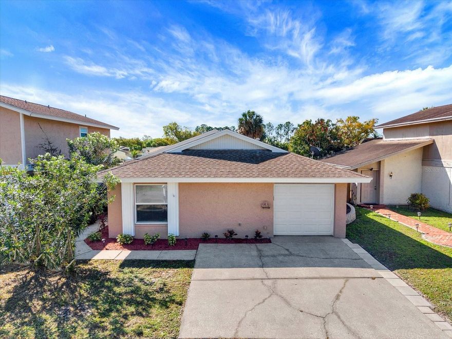 LAKEFRONT living in the highly desirable Carrollwood! This move-in-ready 3 bedroom, 2 bath home in the Plantation offers the perfect blend of comfort, location, and lifestyle, ideal as a starter home or low-maintenance retirement home. The home features an open floor plan with vaulted ceilings, creating a bright and spacious feel. Nicely appointed kitchen includes granite countertops, stainless steel appliances, and a large island, perfect for cooking and entertaining. Sliding glass doors lead to a private porch area ideal for grilling and relaxing. The primary suite offers a spacious walk-in closet and updated en-suite bath, while two additional bedrooms share a nicely updated second bathroom. Enjoy peaceful outdoor living in the fenced backyard with beautiful lake views just beyond the fence. Shed is included! Additional highlights include fresh interior paint, new flooring in the living area, a new water heater, upgraded landscaping, a 1-car garage with washer/dryer, and a double driveway for extra parking. Low HOA and no CDD. Residents of the Plantation enjoy great amenities including a Clubhouse, tennis courts, baseball, volleyball and soccer fields; swimming pools, handball courts, a playground, walking trails and more. Prime location near Citrus Park Mall, restaurants, Tampa International Airport, Raymond James Stadium, USF, Busch Gardens, and major roadways. Schedule your showing today - lakefront homes in Carrollwood don’t last long!