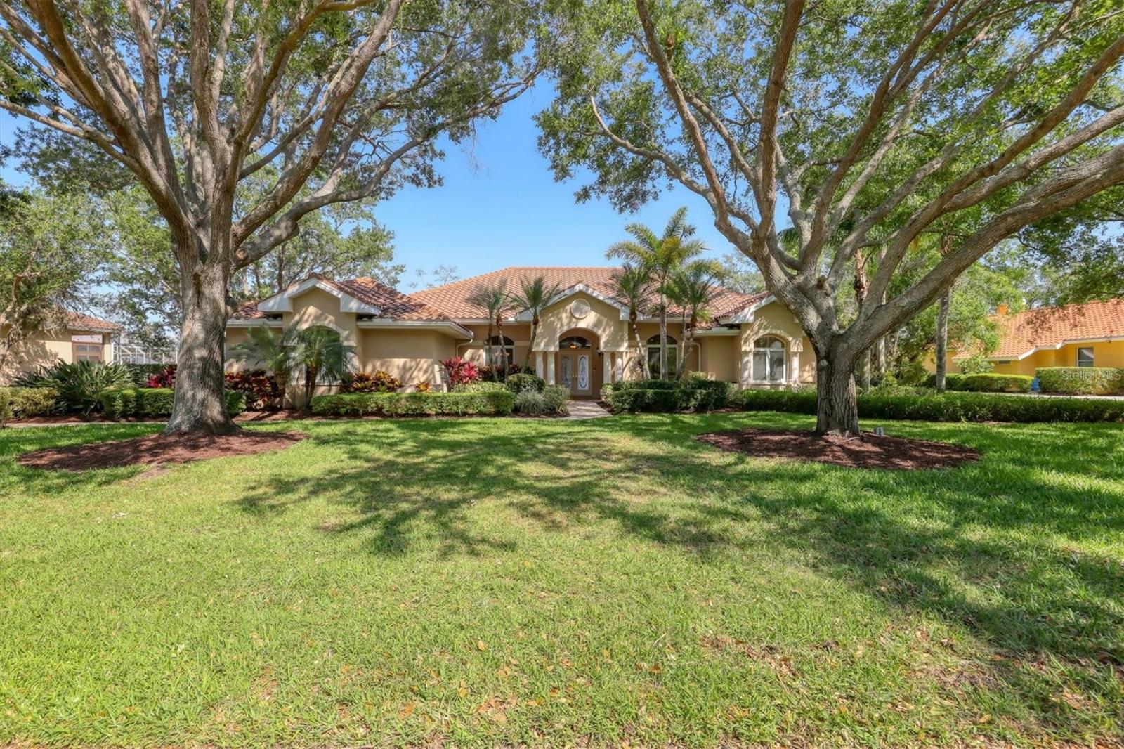 One or more photo(s) has been virtually staged. Nestled on slightly over 1/2 an acre in a picturesque setting of majestic oak canopies, and lush tropical foliage a custom-built home awaits. This property combines comfort, privacy, and breathtaking views offering a true Florida lifestyle in one of Sarasota's most desired gated golf communities, Serenoa. This beautifully designed residence features a spacious 2,848sq split floor plan offering, three bedrooms, three full bathrooms a formal living room, a family room, and a private office. The property has sliders throughout providing expansive views of the lake & 5th fairway filling each room with natural light. The primary suite is a peaceful retreat with french doors that open to the patio, while the en-suit bath provides two generous walk- in closets with a soaking tub and walk in- shower. The open concept living and dining areas provide the perfect setting for entertaining, while the breakfast nook with its large aquarium window offers a tranquil start to your day. A cozy fireplace in the family room adds warmth and charm, creating an inviting space to relax. Step outside to a must-see patio, where the saltwater pool and spa provide year-round enjoyment under the Florida sun. The outdoor kitchen is fully equipped with built-in grill, mini fridge, bar seating, and a true pool bath with shower-perfect for entertaining guest in style. The garage provides ample space to park two vehicles, along with built-in cabinets for additional storage. The property is also equipped with a well for the irrigation system, helping to ensure the landscape remains lush and beautiful. Serenoa is truly a one-of-a-kind community, each property situated on at least a half acre surrounding a beautifully maintained golf course nestled among mature oak trees, lush foliage, wildlife and multiple lakes, creating a picturesque and serene environment. Tennis and pickleball courts are available to all residents. ** Golf course membership is optional * Whitetails bar & Grill located at the club house provides on-site casual dining a perfect spot for socializing or grabbing a bite close to home. Conveniently located near, Publix, Twin lakes park, shopping, and just a short drive away from award winning Siesta Key beach, and UTC town center. *** EXTREMELY LOW HOA Fees** Improvements include**2015 Tile Roof **2018 NEW AC **2021 WATER HEATER ***2022 PROPERTY RE-PIPED***2025 NEW POOL CAGE***2025 New carpet***