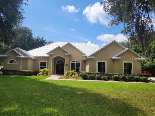 Price reduced 20K for this beautiful custom-built single-family home, constructed in 2007, is situated on a 1-acre lot in Groveland, Florida. The residence offers 3,137 square feet of living space, featuring 3 bedrooms and 3.5 bathrooms. An oversized office provides additional flexible space, potentially serving as a fourth bedroom. The property includes a spacious second living area with a half bath, ideal for entertaining or relaxation. A gourmet kitchen with custom cabinetry, large island with seating, marble counter tops & coffered ceilings. The home is also equipped with a generator hook up for emergencies and an oversized garage. An extended back porch with fire pit is a great area for entertaining. Schedule a showing today & don't miss out.