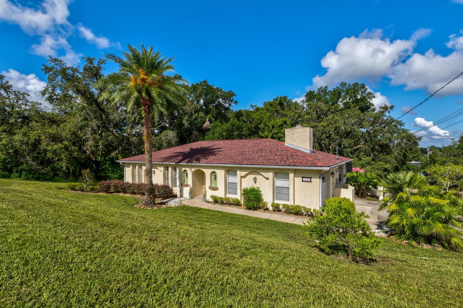 Comfortable Pool Home invites relaxation and welcomes entertaining. Floor plan features 4 bedrooms and 2 full baths on a large corner lot with fenced back yard. Featuring a covered Balcony with wrought-iron railing overlooking the screen enclosed pool. Gorgeous wood floors in the living areas with a fireplace in the Family Room. New roof in February 2025. The lot next to the property is also available separately, G5099354, possibility to expand. Put this one on your list of Must See!