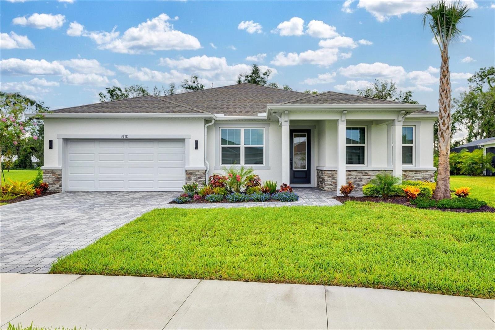 This immaculate 2024-built home, located in the gated new construction community of Windwater is ready for its new owners! With over $35,000 in thoughtful post-builder upgrades, this nearly 3,100 square foot home blends modern elegance with exceptional functionality. Boasting 4 bedrooms, 3.5 bathrooms, a dedicated office, a game room, and a 3-car tandem garage, this layout was designed to elevate everyday living. From the moment you enter, French doors open to a spacious office perfect for working from home. The open-concept floor plan is accentuated by luxury vinyl plank flooring and bathed in natural light, creating a warm and inviting ambiance. At the heart of the home, the executive kitchen is a showstopper—featuring an oversized island, 42" cabinetry, sleek Carrara Breve quartz countertops, and a full suite of stainless steel Kitchenaid appliances (Frigidaire refrigerator included). The adjoining game room offers a built-in wet bar, making it the perfect flex space for entertaining. Tucked away for privacy, the owner’s suite feels like a personal retreat with sliding glass doors to the backyard and a luxurious en-suite bathroom featuring dual vanities, a glass-enclosed shower, and two walk-in closets. Secondary bedrooms are generously sized, with one offering its own private en-suite—ideal for guests or multi-generational living. Step outside to the protected covered patio, where peaceful views of the preserve provide the perfect backdrop for relaxing or entertaining. Already pre-plumbed for a summer kitchen, a large concrete slab has been poured ready for a future pool system, and the area is pre-wired for a hot tub—making it easy to bring your backyard oasis to life. Additional features include an interior laundry room with ample storage and a utility sink, epoxy-coated garage floors with plumbing for a future sink, and hurricane-rated impact windows and doors throughout. Windwater is ideally located near US-301, offering an easy commute to I-75, Tampa, and St. Pete. Spend weekends kayaking along the nearby Manatee River or exploring local shopping and dining options. Come see why Parrish is one of the Gulf Coast’s fastest-growing communities and make this stunning home yours today.