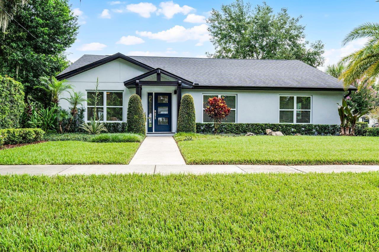 From the outside in, this home is stunning and sure to please the most discerning palette. 2060SF of living space featuring 3 bedrooms, 2 bathrooms and 2 Car Rear Entry Garage are framed by a meticulously maintained yard with landscaping that creates a serene and welcoming curb appeal. Step through the Covered Entryway into a spacious and thoughtfully designed layout with Luxury Vinyl Plank flooring along with recessed and designer lighting throughout the open-concept space that contribute to the elegant and cohesive aesthetic. The kitchen is a true highlight, perfect for the cook who also likes to entertain. The Shaker Cabinets are complimented by a beautiful tile backsplash, ample Quartz Countertop space, soft-close doors and drawers, Stainless-Steel Appliances and an Island with Breakfast Bar. Open to the Kitchen is the Dining Room. A perfect place for serving those freshly created meals. With a Split Plan, the large primary bedroom provides a tranquil retreat. The en-suite bathroom features an elegant space with a dual vanity and glass enclosed tiled shower creating a spa-like feel. Here you will also find the walk-in closet with built-ins, a linen closet and the water closet. The additional bedrooms offer generous space with access to the Guest Bath that is also very nicely appointed with beautiful tile work and elegant details. The outdoor area is a true oasis with a Screened Patio, lush greenery, and a spacious lawn surrounded by mature trees and tropical foliage, highlighted by lighting for nighttime enjoyment. Perfectly located with quick, easy access to The Hourglass District and Downtown Orlando for a plethora of Dining Options. Enjoy peace of mind with this 2018 build home. Schedule your showing today.