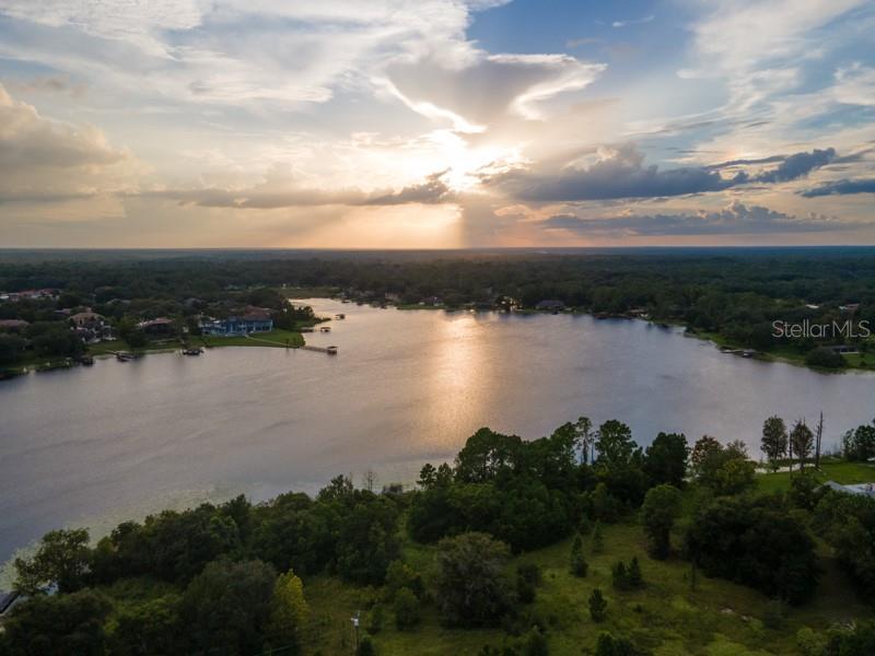 Live. Life. Lakefront. An extraordinary opportunity unfolds along the shores of Lake Markham, where more than 6 acres invite the creation of a legacy estate or multi-generational compound. On the desired eastern shoreline, this rare, high-and-dry property offers a level landscape and the most enchanting sunset vistas over shimmering waters. Here, possibilities abound. Design an architectural masterpiece of grand scale, framed by nature’s beauty and complemented by the exclusivity of a location surrounded by distinguished lakefront estates. This offering is one of four parcels now available to new owners. With no HOA restrictions, the freedom to realize your vision is limitless, whether acquiring the entire offering or selecting from four individually available parcels. Moments from boutique shopping, fine dining, acclaimed golf and country clubs, major thoroughfares, premier hospitals, and an abundance of scenic trails, this remarkable property blends unrivaled privacy with exceptional convenience. Live the extraordinary on sought-after Lake Markham.