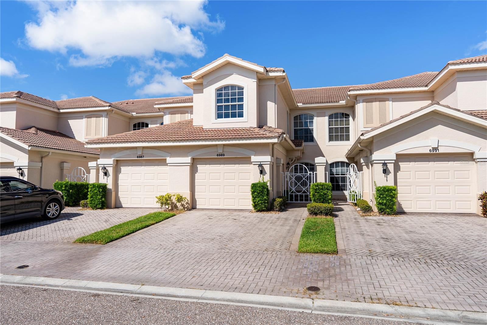 Welcome to Arielle on Palmer Ranch! This spacious 3-bedroom, 2-bath condominium offers over 1,860 square feet of comfortable living in one of Sarasota’s most desirable gated communities. Built in 2005, this home combines a functional layout with peaceful preserve views, perfect for everyday living or a seasonal retreat.
Step inside through your private courtyard entry and up a single flight of stairs to an open-concept living and dining space filled with natural light. A large screened lanai overlooks the lush, wooded preserve—ideal for morning coffee or evening relaxation. The kitchen features wood cabinetry, solid-surface counters with a breakfast bar that flows seamlessly into the living area.
The split-bedroom design ensures privacy for all. Double French doors open to the first bedroom, which shares a Jack-and-Jill bath with the second bedroom. On the opposite side, the primary suite offers two custom installed installed walk-in closets, dual sinks, and a spacious shower. Additional highlights include a full-size laundry room, neutral paint palette, and an attached one-car garage.
Residents of Arielle enjoy resort-style amenities including a heated pool, spa, and community cabana. The location is unbeatable—just minutes to Siesta Key Beach, Legacy Trail, shopping, dining, and I-75.
This move-in ready condo offers the perfect blend of space, convenience, and lifestyle in the heart of Palmer Ranch.