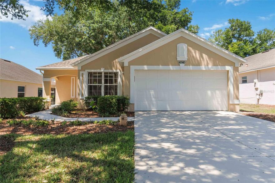One or more photo(s) has been virtually staged. Welcome to 3624 Westerham Drive in the highly desirable KINGS RIDGE 55+ guard-gated golf community in Clermont, Florida, where resort-style living meets everyday convenience. Known for its rolling hills, championship golf courses, scenic trails, and vibrant active-adult lifestyle, Kings Ridge offers the perfect blend of relaxation, recreation, and social living in one of Central Florida’s most sought-after communities. This beautifully updated Tiffany model features 2 bedrooms, 2 full bathrooms, and an oversized 1-car garage with space for a golf cart, making it ideal for low-maintenance living without sacrificing space or comfort. From the moment you arrive, you’ll notice the care and recent improvements, including fresh exterior paint, newly painted driveway and walkway, enhancing both curb appeal and functionality. Inside, the home has also been freshly painted, including the garage walls, and features a new HVAC unit for year-round comfort. Step inside to a bright and inviting layout with beautiful laminate and tile flooring throughout the main living areas. The open-concept design flows effortlessly from the formal dining space into the spacious family room, kitchen, and breakfast nook, creating the perfect setting for entertaining or everyday living. The fully renovated kitchen is a standout, featuring granite countertops, upgraded cabinetry with ample storage, stainless appliances, and a convenient breakfast bar for casual dining. Both bathrooms have been tastefully updated, including the guest bath with a walk-in shower and granite countertops, while the private primary suite offers a peaceful retreat with its own wing, a renovated spa-like bathroom, and a beautiful walk-in shower. Step through the sliding glass doors to your large screened-in lanai, perfect for enjoying Florida’s year-round sunshine, relaxing with a morning coffee, or hosting friends and family. Living in Kings Ridge means access to an unmatched array of resort-style amenities, including three pools, two golf courses, tennis courts, pickleball, fitness centers, shuffleboard, billiards, a jacuzzi, and a stunning clubhouse. Residents enjoy a full calendar of social events, clubs, classes, dinner dances, and live entertainment, creating a true community atmosphere. The HOA also includes lawn care, exterior painting, cable, internet, and phone, adding convenience and value. Ideally located just minutes from the Florida Turnpike, shopping, dining, medical facilities, and Lake-Sumter State College, with Disney, Universal, SeaWorld, and Orlando International Airport all within easy reach, this home offers both lifestyle and location. If you’ve been searching for a move-in-ready home in a premier 55+ golf community with modern updates and resort-style amenities, this is your opportunity to enjoy the best of Central Florida living year-round. Schedule your private showing today!