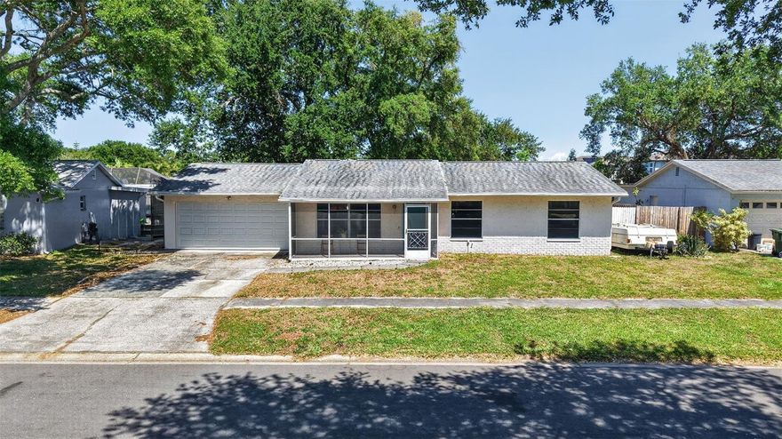 This beautifully maintained 3-bedroom, 2-bathroom home is perfectly situated in the heart of Clearwater, offering the unique lifestyle and flexibility of being in unincorporated Pinellas County. Peace of mind comes standard here, as the property sits high and dry in a non-flood zone, completely eliminating the requirement for flood insurance. The home includes a primary bedroom complete with a private en suite bathroom. The functional, turn-key layout is further highlighted by a massive 467-square-foot family room with soaring high ceilings, creating an impressive environment ideal for large-scale entertaining or cozy movie nights. For year-round comfort and energy efficiency, both this expansive family room and the 2-car garage are equipped with high-efficiency mini-split A/C systems, making the garage a perfect space for a home gym, workshop, or climate-controlled storage. The interior flows seamlessly to the outdoors, emphasizing a true indoor-outdoor living experience. The home sits on a spacious lot designed for ultimate enjoyment; whether you're relaxing on the enclosed patio, gathering around the firepit, or enjoying the private playground, there is plenty of room for hosting guests and enjoying the Florida sunshine. Located near top-rated beaches and shopping, this property is a true standout for those who prioritize both climate-controlled comfort and a generous outdoor lifestyle.