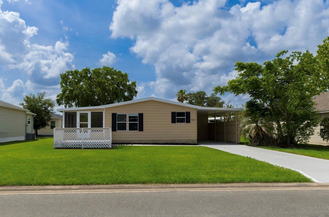 Welcome to 1220 Dustin Drive, a move-in-ready retreat in the peaceful community of Lady Lake. This beautifully upgraded 2-bedroom, 2-bath home offers an open layout with luxury vinyl flooring, a bright kitchen with ample cabinetry, and spacious living and dining areas. The sunlit Florida room provides extra space to relax or entertain. Enjoy peace of mind with a new roof, new siding, updated electrical and plumbing. Step outside to a private patio and deck—perfect for morning coffee or weekend gatherings. A golf cart garage adds extra convenience. Set on a quiet street with mature landscaping, this home is just minutes from The Villages, top golf courses, shopping, and dining. Ideal as a full-time residence or seasonal escape, this home blends comfort, style, and location.