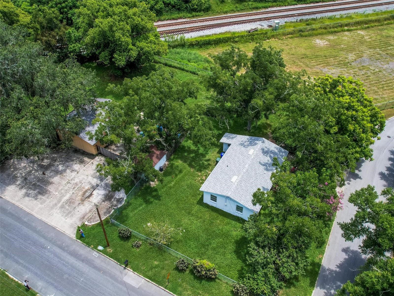 Prime industrial property for sale, zoned I-1. The sale includes two additional parcels (23-28-11-031500-001220 and 23-28-11-031500-001240), totaling 0.6 acres. This versatile property is ideal for light manufacturing, warehousing, distribution, fruit or vegetable packing plants, machine shops, and more. The site also features a 3-bed, 1-bath home sold as-is. Convenient access to major highways and transportation hubs makes this a strategic investment opportunity. Essential utilities are available, ensuring a smooth transition for your business. In addition to its industrial potential, the property boasts lush vegetation, including banana trees, nut trees, and vibrant cacti, creating a unique and appealing environment. There is also a workshop on-site, providing extra space for various projects or storage needs. This combination of industrial and natural features makes a distinctive and attractive option for your business.
