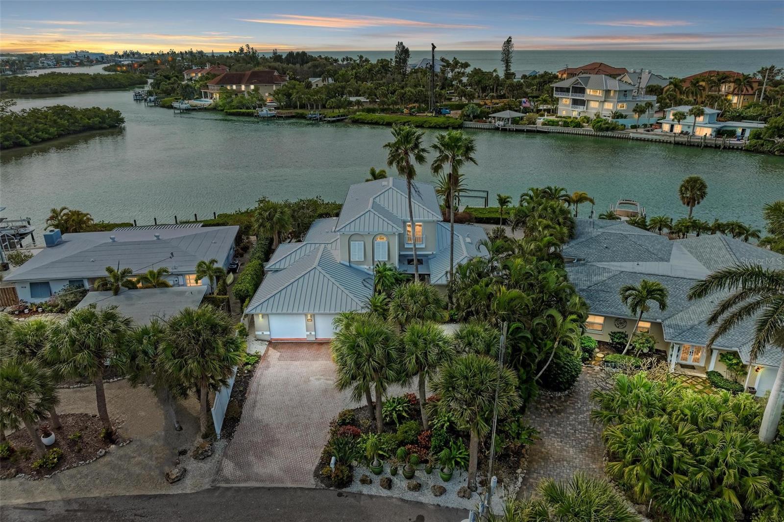 ***3D Matterport Tour Available***Indulge in the epitome of waterfront luxury at this elegant Casey Key retreat, where the allure of gulf-to-bay views takes center stage. This 4-bedroom, 4-bathroom pool home spans two floors, offering a private oasis designed with meticulous attention to detail.
Nestled along the picturesque shores of Blackburn Bay, this residence boasts an EXCLUSIVE DEEDED GATED PRIVATE BEACH ACCESS and DIRECT ACCESS to the Intracoastal Waterway, with water access depths of 6+ feet. Boaters will find their dream come true with depths of approximately 25' (4' at low tide), transforming the Intracoastal Waterway into a playground that seamlessly provides access to the Gulf of Mexico, a mere 2 miles away. The dock, equipped with a lift and a kayak launch, awaits your maritime adventures.
As you arrive, lush and well-maintained grounds lead to the entrance of the home. Enter, and the coastal elegance of the surroundings seamlessly transitions into the interior. The first floor invites you with a harmonious flow of spaces, featuring an elegant kitchen adorned with new appliances, a spacious dining room, a cozy nook, and a living room that opens to the picturesque pool and travertine patio. Three guest suites and a convenient laundry room complete the first floor, ensuring both comfort and functionality.
Ascend to the second floor, where the owner's suite reigns supreme. Take in breathtaking bay views from the private balcony, a perfect spot to begin and end the day. Witness dolphins and manatees gracefully navigating the waters, creating a tranquil backdrop to relax in blissful serenity. A tray ceiling adds an elegant touch to the primary bedroom, complemented by a spacious bathroom featuring a soaking bath and a walk-in shower. A private study off the suite offers a quiet retreat to read, work, or simply unwind.
Luxury details, including high ceilings, arches, and columns on the first floor, seamlessly blend with the newer travertine flooring, creating an interior that harmonizes with the tropical allure of the property. Abundant natural light fills the spaces, creating a vibrant and inviting atmosphere. The entire home is a showcase of recent upgrades, boasting a NEW ROOF, interior and exterior paint, updated impact windows, and a new HVAC and water heater.
The REMODELED POOL, nestled amidst meticulously landscaped surroundings, beckons with its refreshing allure, becoming a centerpiece of relaxation. Conveniently located near Nokomis Beach, historic Venice Island, downtown Sarasota, restaurants, shopping, and the Legacy Trail, this home seamlessly blends accessibility with the irresistible charm of a tropical getaway.
Immerse yourself in elevated waterfront living, where the interior spaces complement the natural beauty of Casey Key, creating a truly exceptional and tropical living experience.