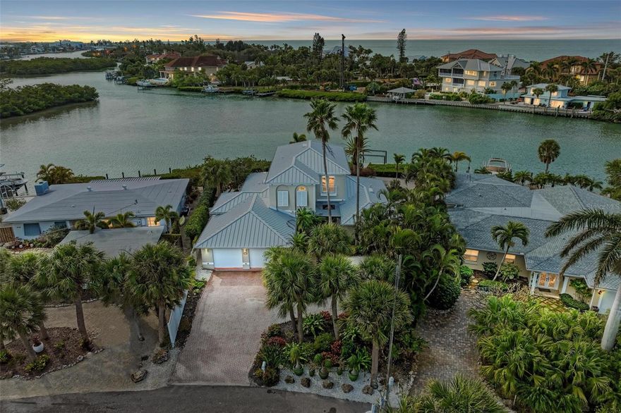 ***3D Matterport Tour Available***Indulge in the epitome of waterfront luxury at this elegant Casey Key retreat, where the allure of gulf-to-bay views takes center stage. This 4-bedroom, 4-bathroom pool home spans two floors, offering a private oasis designed with meticulous attention to detail.

Nestled along the picturesque shores of Blackburn Bay, this residence boasts an EXCLUSIVE DEEDED GATED PRIVATE BEACH ACCESS and DIRECT ACCESS to the Intracoastal Waterway, with water access depths of 6+ feet. Boaters will find their dream come true with depths of approximately 25' (4' at low tide), transforming the Intracoastal Waterway into a playground that seamlessly provides access to the Gulf of Mexico, a mere 2 miles away. The dock, equipped with a lift and a kayak launch, awaits your maritime adventures.

As you arrive, lush and well-maintained grounds lead to the entrance of the home. Enter, and the coastal elegance of the surroundings seamlessly transitions into the interior. The first floor invites you with a harmonious flow of spaces, featuring an elegant kitchen adorned with new appliances, a spacious dining room, a cozy nook, and a living room that opens to the picturesque pool and travertine patio. Three guest suites and a convenient laundry room complete the first floor, ensuring both comfort and functionality.

Ascend to the second floor, where the owner's suite reigns supreme. Take in breathtaking bay views from the private balcony, a perfect spot to begin and end the day. Witness dolphins and manatees gracefully navigating the waters, creating a tranquil backdrop to relax in blissful serenity. A tray ceiling adds an elegant touch to the primary bedroom, complemented by a spacious bathroom featuring a soaking bath and a walk-in shower. A private study off the suite offers a quiet retreat to read, work, or simply unwind.

Luxury details, including high ceilings, arches, and columns on the first floor, seamlessly blend with the newer travertine flooring, creating an interior that harmonizes with the tropical allure of the property. Abundant natural light fills the spaces, creating a vibrant and inviting atmosphere. The entire home is a showcase of recent upgrades, boasting a NEW ROOF, interior and exterior paint, updated impact windows, and a new HVAC and water heater.

The REMODELED POOL, nestled amidst meticulously landscaped surroundings, beckons with its refreshing allure, becoming a centerpiece of relaxation. Conveniently located near Nokomis Beach, historic Venice Island, downtown Sarasota, restaurants, shopping, and the Legacy Trail, this home seamlessly blends accessibility with the irresistible charm of a tropical getaway.

Immerse yourself in elevated waterfront living, where the interior spaces complement the natural beauty of Casey Key, creating a truly exceptional and tropical living experience.