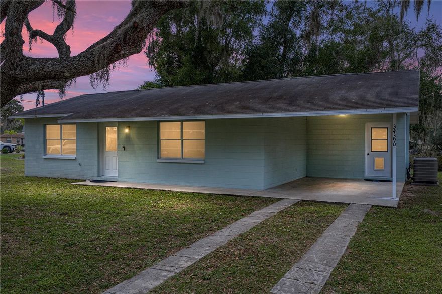 Set beneath the shade of mature trees on nearly 1/2 an acre in the Ridge Manor area of north Dade City, this home offers a peaceful everyday setting away from the hustle and bustle, but with the convenience of nearby shops and essentials just a short drive away. Featuring 3 bedrooms, 2 bathrooms, and a collection of thoughtful updates, it’s a great match for a first time buyer or anyone hoping to downsize into something easy to maintain. Inside, the floor plan opens up with an easygoing layout that keeps the kitchen, dining space, and living area connected. The eat-in kitchen has been beautifully refreshed with butcher block countertops finished with a waterfall edge, stainless steel appliances, painted cabinetry, updated lighting, and a backsplash that brings the whole space together. Tile flooring runs throughout, and the laundry room sits right off the kitchen for everyday practicality. The primary suite has its own access to the covered back porch and offers an updated ensuite with a newer vanity, upgraded lighting, an accent wall, open shelving, and a walk-in shower. Bedrooms 2 and 3 sit on the opposite side of the home near the second full bathroom, which has also been nicely updated and includes a tub and shower combo. Out back, the covered patio provides a serene spot to unwind while looking over the expansive backyard. A storage shed, a 1 car carport, and a 2016 roof add extra value for the new homeowner. If you're looking for an updated home on a spacious lot with true everyday convenience, this Ridge Manor property is worth a look in person. Contact us today to schedule your private tour!