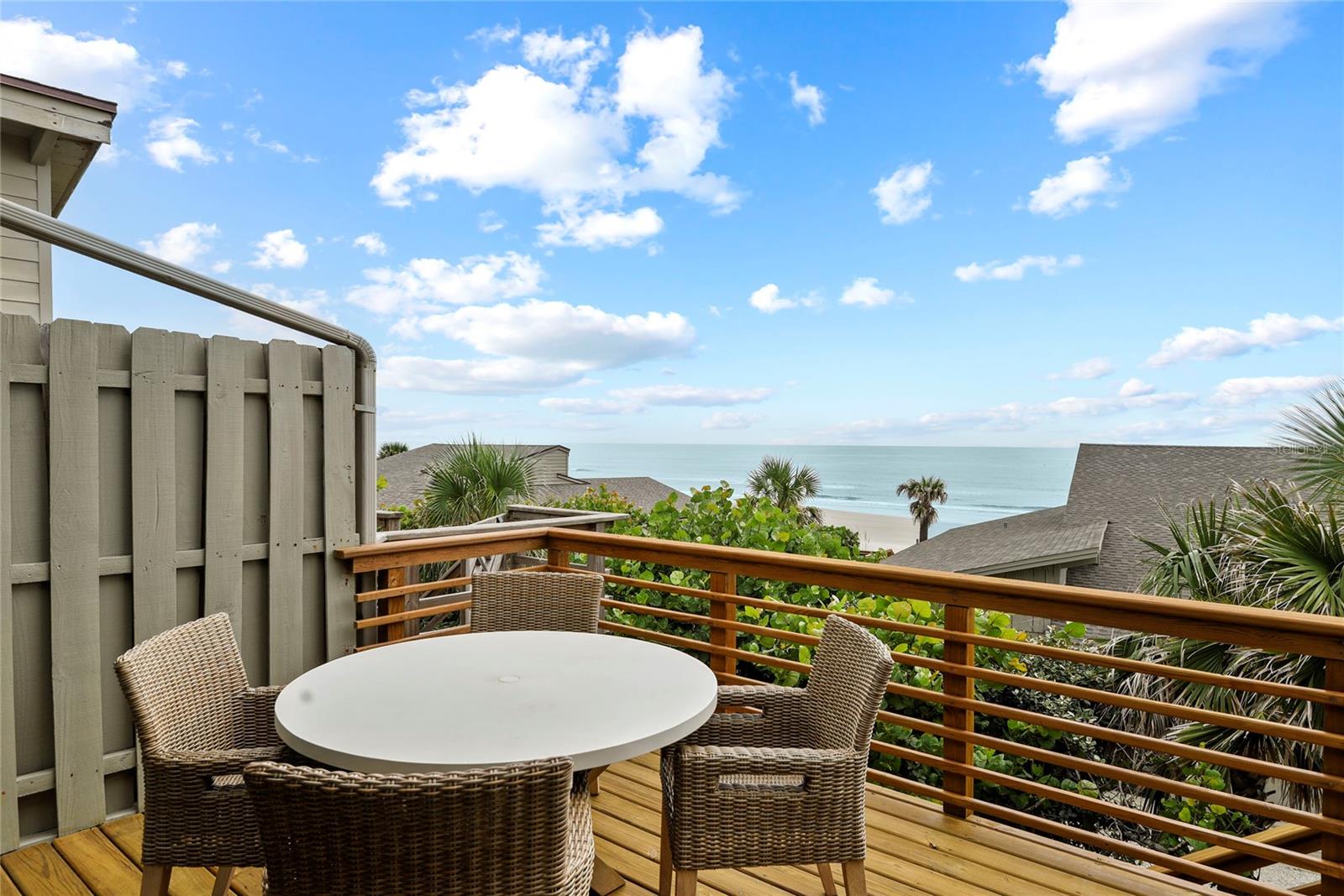 Spectacular Ocean Views and Calming Breezes From the Moment You Enter. This Elegantly Casual Beach Home Wraps Its Arms Around You With An Old Florida Coastal Vibe. Three Bedrooms, Three Full Bathrooms. Located in the Highly Desirable Sea Dunes Nautilus Townhome Community on New Smyrna Beach's NO DRIVE BEACH. The Main Level is located upstairs for Incredible Ocean Views. The Open Floor Plan includes a Spacious Great Room with Vaulted, Beamed Ceilings (featuring cypress and pecky cypress wood paneling), Two En-suite bedrooms, multiple elevated decks, and a Large, Fully Renovated Kitchen. The Kitchen Opens to the Living Spaces and Includes a Dining Area. Downstairs you'll enjoy the spacious, private 1 bedroom, 1 bath Mother-In-Law / Guest apartment for family, guests or renters. The downstairs living area has its own private ground floor entrance and offers a 2nd full kitchen & Great Room. Downstairs you'll also enjoy the Deep One Car Garage with plenty of room for your vehicle, laundry, and beach toys. Complete exterior restoration of B-8 completed in 2023 and 2024. All New Sliders and Windows. The Exterior Restoration included All New Stairs and Decking, Exterior Siding Refurbishment and Exterior Painting. Inside, the Upstairs enjoys a gorgeous new kitchen with solid wood cabinetry, Quartz Counter Tops, Stainless Appliances, Custom Penny Tile Backsplash and Floating Shelves. Roof Installed Feb. 2019. Downstairs A/C 2021. Upstairs A/C 2025. For peace of mind, The entire Sea Dunes Community now enjoys the protection of a sea wall completed in 2024. The Nautilus HOA enjoys private beach stairs. The Ten residences comprising the Nautilus Community share a beautiful Pool & Tennis Court. Nautilus HOA allows short term rentals. This Beautiful Ocean Front Residence is offered furnished. However, All Art is Excluded. Seller to provide list of any Excluded Personal Property within Inspection Period. All measurements are approximate, and Buyer responsible to verify all dimensions.
