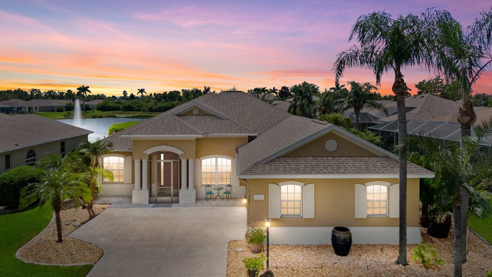 Amazing opportunity to own a beautifully upgraded waterfront 3/3 plus den home in the sought-after community of Lexington Estates built by the custom builder Bruce Williams. This exceptional residence features a one-of-a-kind Grecian Key-shaped pool and spa that has been resurfaced and is surrounded by a new panorama screen enclosure that overlooks the lake with a lit up fountain at night. The backyard is an entertainer’s dream, complete with a custom Paradise Grills lighted Tiki Bar with hibachi grill, outdoor TV with bluetooth app technology, and an extended patio area ideal for gatherings. This home is sure to be your oasis after a long day. Step inside to an open floor plan that is showcased by soaring vaulted ceilings and crown molding. The kitchen offers generous space with granite backsplash and a large custom curved granite breakfast bar, a spacious pantry, and a breakfast nook with an aquarium window overlooking the pool. A formal dining room adds to the home’s appeal, along with numerous interior enhancements including plantation shutters, a desk off the kitchen, and UV film protection on the western-facing windows. Recent upgrades include a 2022 HVAC system, a 2021 roof, a water heater booster, and a Pentair pool system. The two-car side-load garage has been extended, features a painted floor, screened-in garage door, and an added portable A/C unit to use at your large custom work bench in the garage…every man’s dream. The front of the home boasts a concrete etched driveway and covered porch, framed by lush landscaping with river rock and curbing around the entire perimeter. (see full list of all upgrades in attachment) Additional improvements include updated kitchen appliances, granite, backsplash, under counter kitchen lighting and automated outdoor lighting, screened lanai. This meticulously maintained property offers the best of Florida living in a peaceful waterfront setting, with every detail thoughtfully designed for comfort, style, and functionality. This is the perfect place to call home in paradise. Quick access to I-75, St Pete and Tampa International airport. Lexington is located near great schools and plenty of restaurants and many famous beaches.