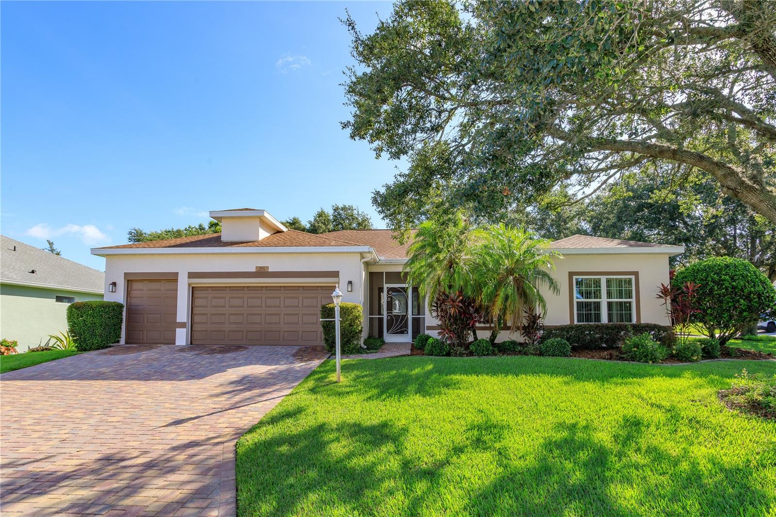 Welcome to this beautifully maintained 3-bedroom, 2-bath home located on a spacious corner lot in the highly sought-after 24 HOUR GUARD GATED 55+golf community of The Plantations. This light-filled, open-concept home features laminate flooring thought the main living areas while tile is in the kitchen. There is a spacious living and dining area, sliding glass doors that lead to a sunny Florida room-perfect for year-round enjoyment. The Florida room and home include three-pane windows, allowing you to soak in natural light or close it off during the cooler months. The split-bedroom layout offers privacy and flexibility. One of the bedrooms is currently used as an office, complete with built-in desk and shelving-ideal for remote work or a hobby space. The primary suite features its own private entrance to the Florida room, a luxurious en-suite bath with a soaking tub, walk-in shower, private toilet closet, and a spacious walk-in closet outfitted with ample shelving, including dedicated shoe storage. The kitchen includes a cozy dinette area and is perfect for casual meals or morning coffee. The huge living room is open to the dining room making entertaining a breeze. Additional upgrades include water softener, roof (2018), and retractable garage screen. Located in The Plantations, residents enjoy access to resort-style amenities, including a championship golf course, clubhouse, fitness center, swimming pool, pickleball, tennis, basketball courts, and so much more with planned activities. Bring your golf cart and start living the lifestyle you deserve.