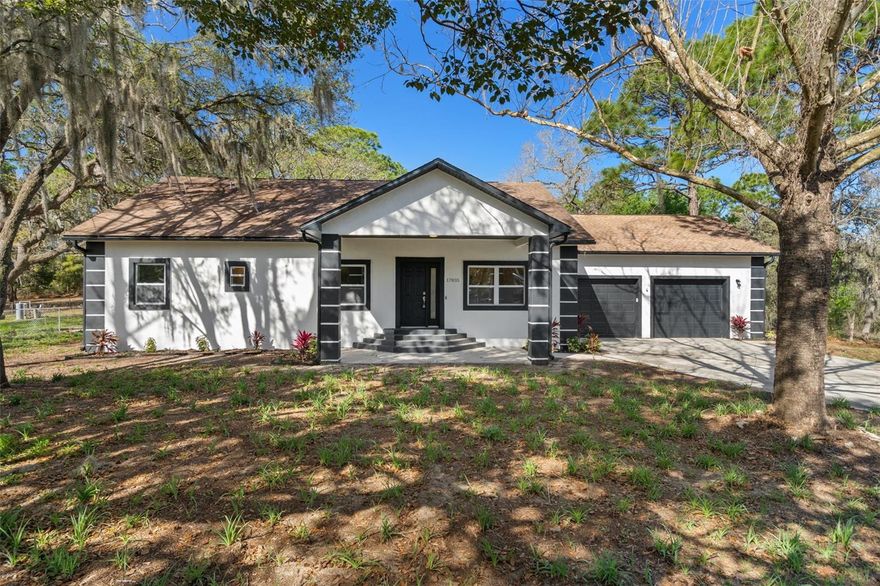 Enjoy the perfect blend of country living and modern convenience with this beautifully remodeled 4 bedroom, 2 bath single-family home situated on just over an acre on a paved road, only minutes from the Suncoast Parkway (589) for an easy commute and quick access to shopping, dining, and everyday amenities. A standout feature of this property is the approximately 750 sq ft detached garage/workshop with impressive 12-foot ceilings and four 8-foot garage doors, designed with pass-through access that allows you to drive straight through to the backyard and continued driveway area—ideal for multiple vehicles, boats, RVs, equipment, or workshop space. Inside, the home features a bright open floor plan with a fully remodeled interior including all new cabinetry, quartz countertops, stainless steel appliances, and durable ceramic tile and laminate flooring throughout with no carpet. Major updates include a new 2025 roof, 2019 HVAC system, and a new water heater for added peace of mind. The property is zoned AR, allowing for a variety of flexible uses, and is located in Flood Zone X. Experience a peaceful country setting with plenty of space while still being close to everything the area has to offer.