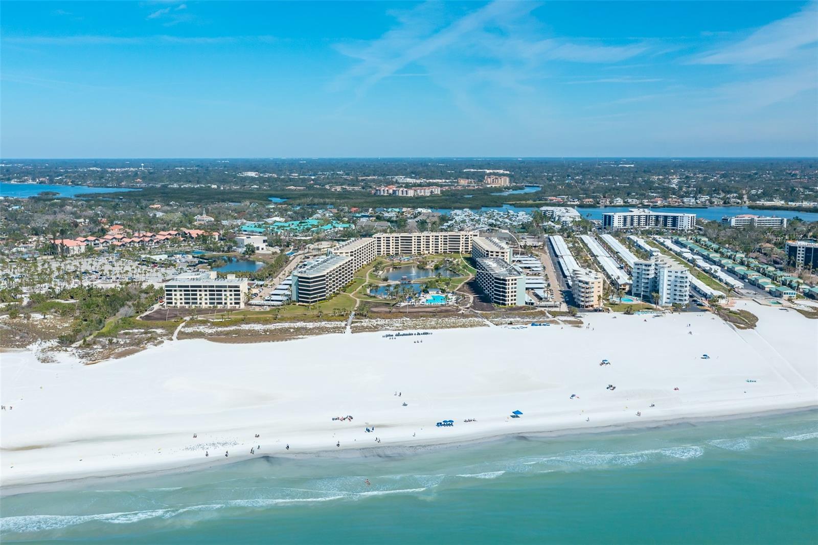Experience resort-style living at Gulf & Bay Club on Siesta Key, with stunning views of the 32-acre gated property and 800 feet of white quartz powder sand beach front. This bright second floor, two-bedroom, two-bathroom CORNER UNIT offers a generous open space. Totally RENOVATED by Yale trained designer Alyssia Lazin Kapic, the European-inspired décor has modern and sleek lines create a luxurious atmosphere. From the enhanced ceilings, gourmet kitchen, office area and smart storage optimization, you will appreciate the level and attention to detail that has been put into creating a welcoming and functional space. Additional upgrades include HURRICANE DOORS AND WINDOWS. As an end unit, the residence has three additional windows that bring light and tropical ambience into the condo. Located with convenient access to world-class amenities that feature a freshwater lake with a rustic footbridge meandering onto a unique island situated in the middle of a lagoon. Enjoy a lush tropical courtyard featuring three heated swimming pools, available Wi-Fi, organized events, two clubhouses, four tennis courts, six pickleball courts, and various other amenities including a fitness center. While there you will enjoy a dry sauna, hot tub, pool tables, and media facility with a print and video library. Electric vehicle charging stations are also steps away. Live like you're on vacation daily at Gulf & Bay Club, where warm hospitality and serenity await.
