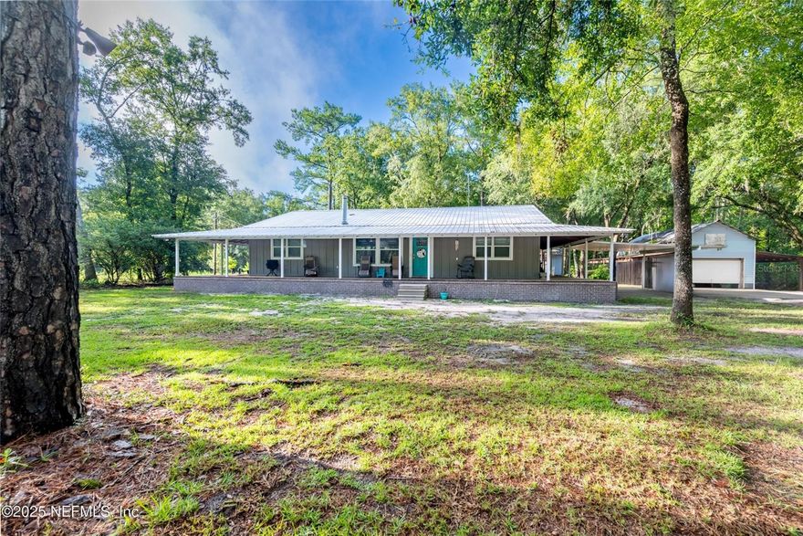 Situated on a secluded 4 acre property in Bradford County is this beautifully renovated 3 bed / 2 bath home! This property includes new windows, A/C, spray foam insulation, tankless water heater, new flooring & paint, updated plumbing & electric, and hardie board siding — all done in 2023. Step out onto the newly done wraparound porch from any of the four doors leading out to enjoy your morning coffee, all while taking in the surrounding wildlife. This would be the perfect fishing paradise as it backs up to Santa Fe River. Enjoy a spacious open floor plan with an office with the potential to be a fourth bedroom, spacious laundry room, and pantry, plus a carport and peaceful country setting. Roof was replaced in 2016. Just move in and enjoy the space!
