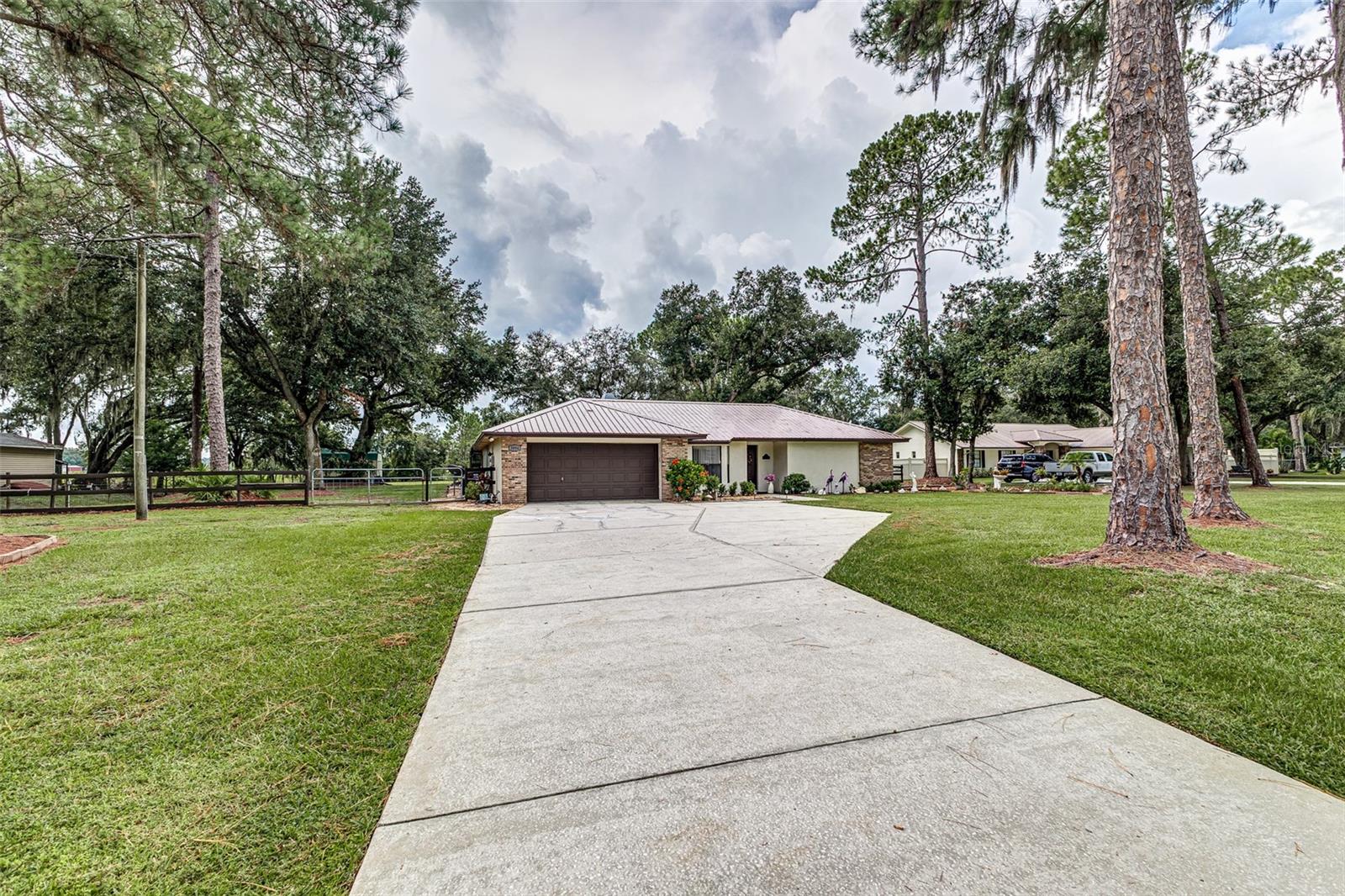 Enjoy the freedom of country living with this beautiful 4 bedroom, 2 bathroom home situated on a full acre of land. With no HOA restrictions, you can truly make this property your own—bring your boats, RVs, trailers, and all your toys! Inside, you’ll find a spacious split floor plan designed for comfortable living. The open kitchen flows into the living and dining areas, perfect for family gatherings or entertaining. Four generous bedrooms provide plenty of space for everyone, and the two full baths are conveniently laid out for daily living. Step outside and take in the space and privacy of your 1-acre lot—whether you want to garden, build a workshop, or simply relax under the open skies, the possibilities are endless. There is a lot of space to utilize the outdoor kitchen for entertaining. This home combines the best of both worlds: peaceful living with plenty of room to spread out, while still being close to local conveniences.