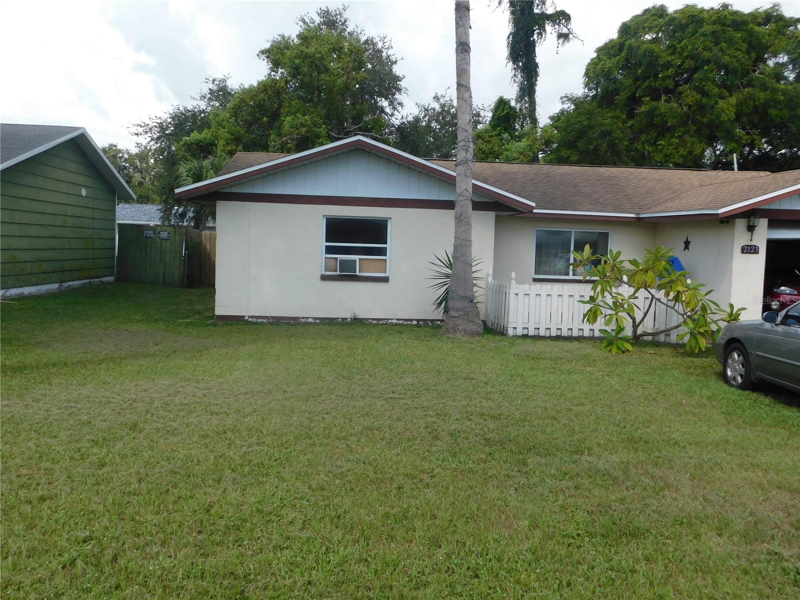 Great Investment Opportunity! First Time Home Buyer! Winter Home! Retirement Home! This may be just what your looking for. This 3-bedroom, 1.5-bath home with a garage is ready for its next owner. No HOA! Roof is just 6 years old and AC is 7 years old and works. For extra comfort, the current owner added window units in two bedrooms. The third bedroom features its own entrance—perfect for rental potential or guest space. Bathroom has been updated with a new tub/shower combo. Home has ring doorbell, security cameras and key-less entry. Enjoy a large, fenced backyard ideal for pets or entertaining. Fantastic location close to shopping, dining, entertainment, Howard Park, Key Vista Park, and more!