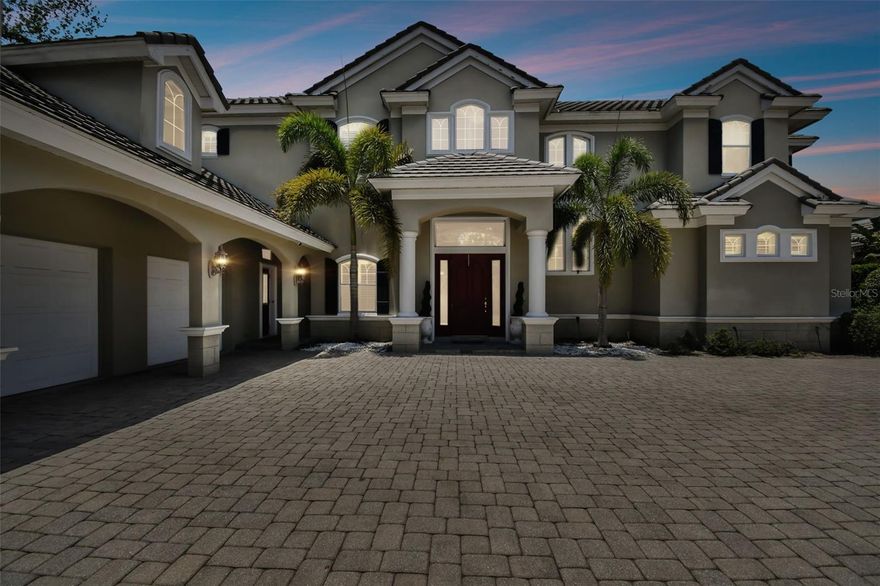 Welcome to 301 Signature Terrace!   Come experience nearly 6,000 square feet of fine architectural craftsmanship in this luxurious residence sitting on a corner private lot.  This state of the art property has 5 Bedrooms, 4 Full Bathrooms,  2 Half guest Bathrooms, 4 Car garages. Nestled on a pristine 1-acre lot in the most luxurious gated Subdivision of Signature Estates of Safety Harbor, this impeccable home offers extraordinary amenities and attention to detail throughout. Enter through a grand two-story foyer featuring 23-foot soaring ceilings and an elegant cascading staircase. The 46-foot mezzanine overlooks breathtaking views of the formal living room, which boasts a dual-sided gas fireplace, crown molding, French doors, and hardwood oak flooring.
Down the hall from the living room, the stately office overlooks the pool lanai, providing a serene workspace. The master suite is a sanctuary, complete with an en suite, Double vanity with dual sinks, garden tub, walk in shower, makeup vanity and island. The 16 feet wide walk in closet with closet system.   O
n opposite side down the hall, The formal dining room, commissioned and designed with wainscoting, three niches, crown molding, and a butler's pantry is perfect for elegant gatherings. The gourmet kitchen is a chef’s dream, featuring a spacious granite island, built-in shelves, cherrywood cabinets, a 6-burner gas cooktop, two full built in ovens, a walk-in pantry, coffered ceiling, buffet with storage, top-of-the-line appliances including 2 dishwashers for quick and easy cleanup and a granite peninsula opening to the custom-tiled 22-foot family room.   Featuring a large secondary dining room next to a cozy gas fireplace.   The family room includes a coffered ceiling, plantation shutters,  and triple French doors that open to the stunning pool pavered lanai. Adjacent to the family room is a bonus / media room with a private screened lanai.

A second stairway leads to three additional bedrooms upstairs, each with walk-in closets. Two bedrooms have en suites full bathrooms and one features a hidden secret room behind bookcase shelves. A separate mother-in-law / guest house  with full bathroom and kitchenette with a private entrance adds even more living space and versatility to this remarkable estate.   The house comes with generator.  Low HOA of $267/month. No CDD. No Flood zone.   
The home's location is key as it is minutes away from Clearwater beach and many other beaches.  A short drive to Tampa international airport. 
Discover unparalleled luxury and sophistication in this modern traditional masterpiece in prime location.   Make this stunning estate your new home!